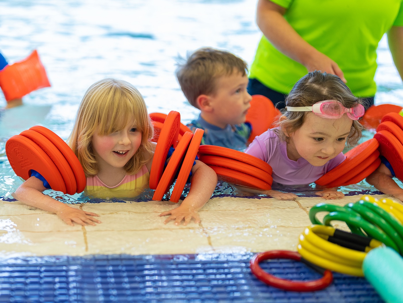 A group of children in armbands learning to swim