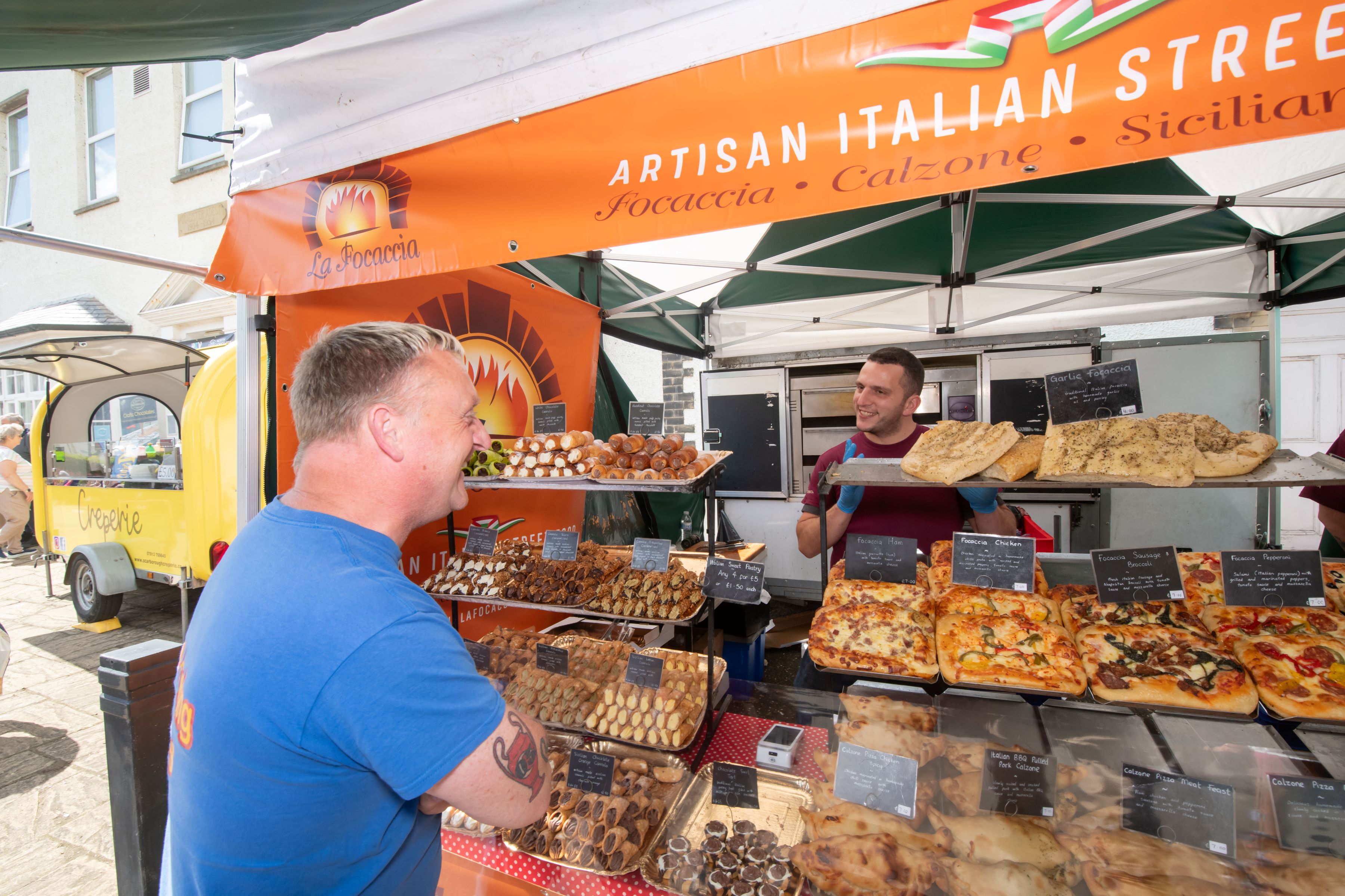 A customer and stallholder sharing in the fantastic atmosphere when Filey Food and Drink Festival was held earlier this year.