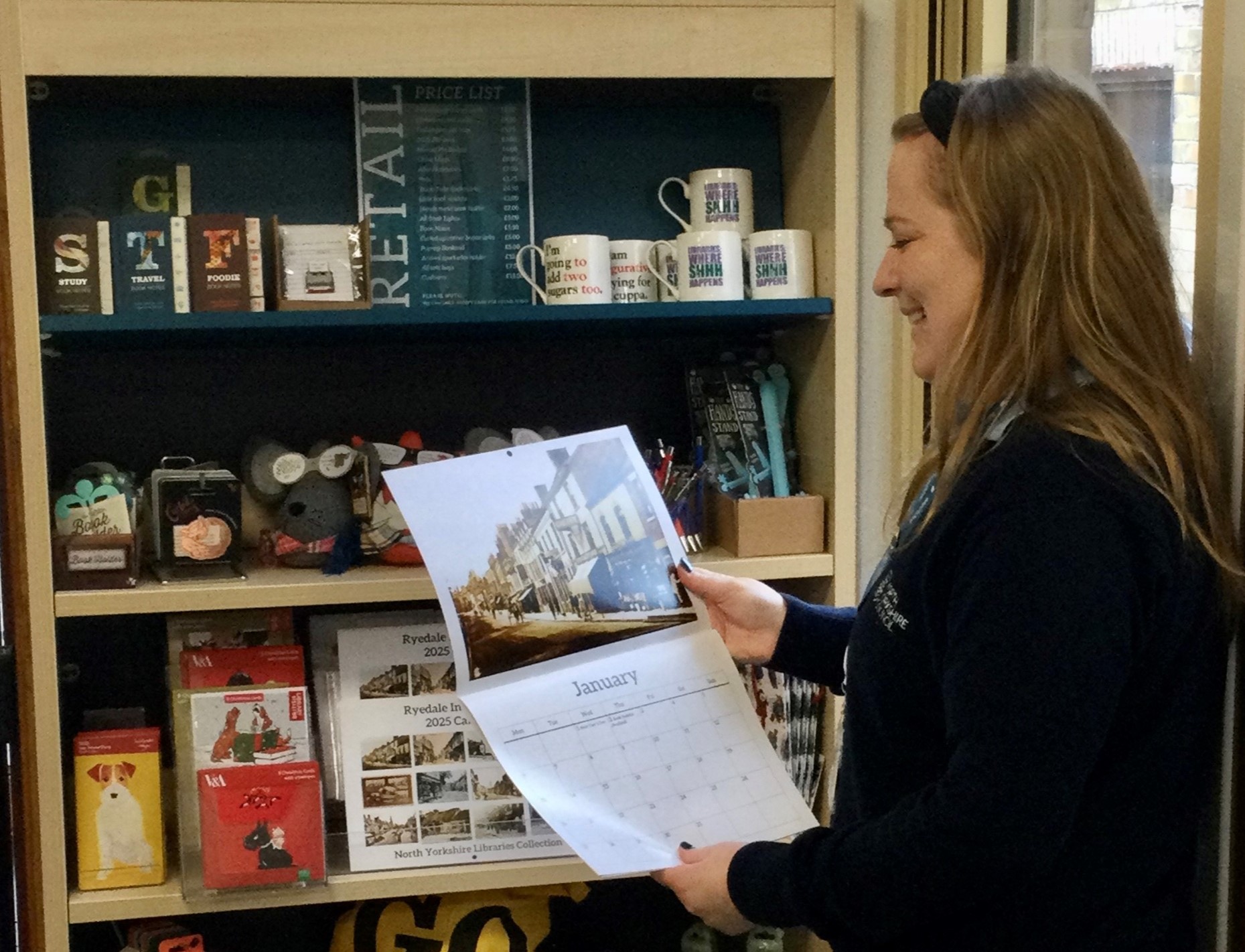 Beccy Roberts, library supervisor, looking at a calendar