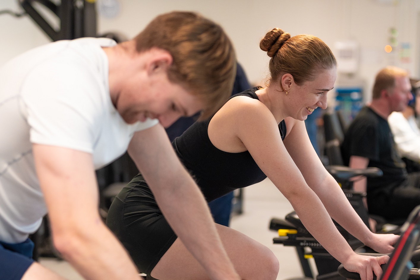 Two people on exercise bikes