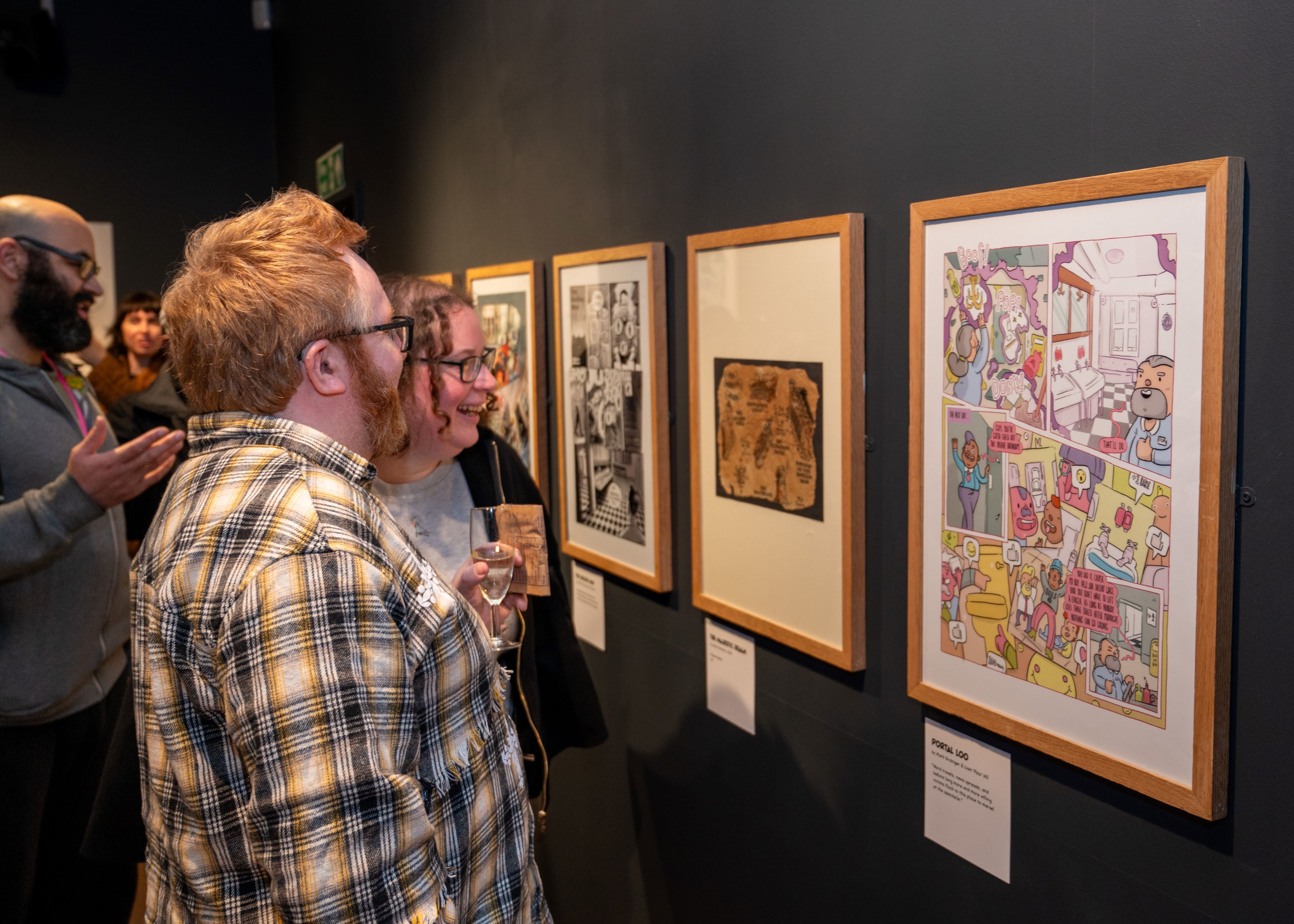 Visitors view the comic art