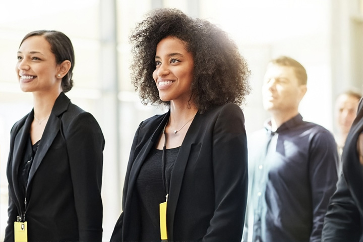 A group of professionals stood in an office