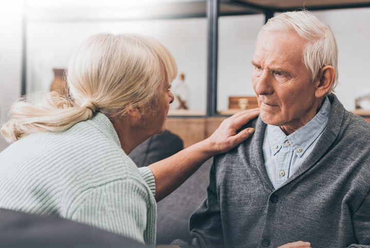 Woman providing support for an older man