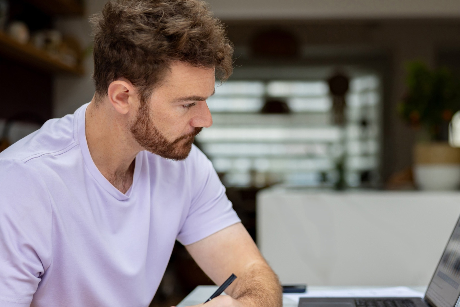 Man working from home looking at his laptop