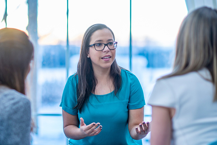 Three woman talking to each other