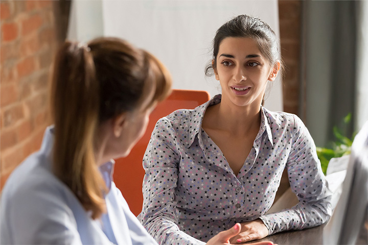 Two women sat in an office and talking