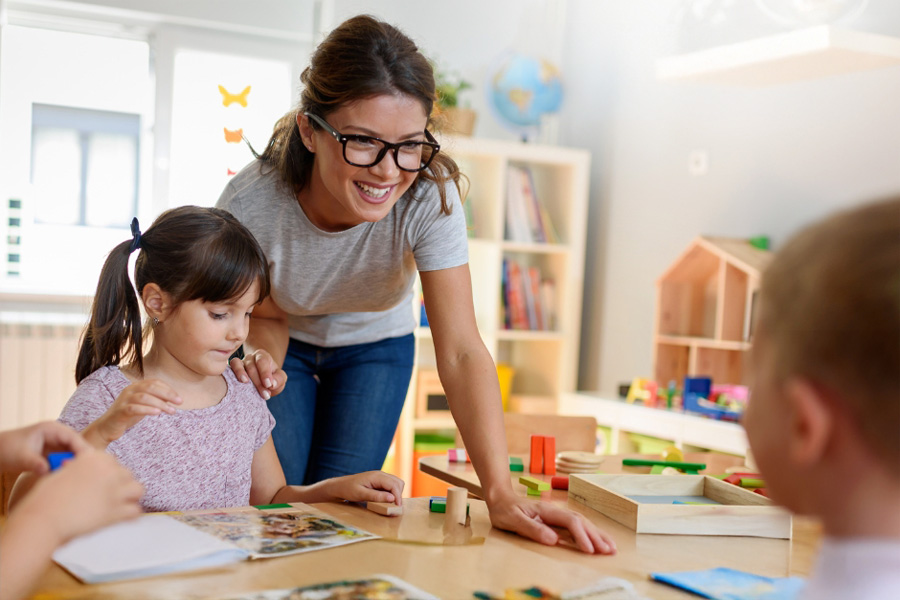 Teacher and two children in a classroom