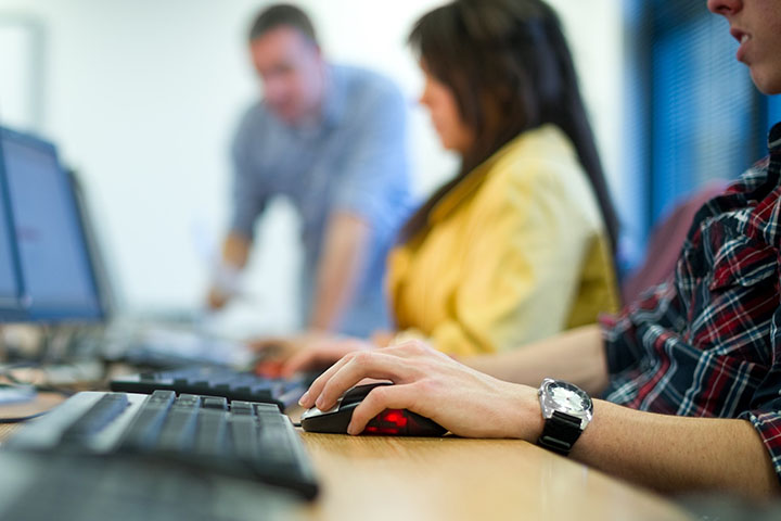 People typing on a computer