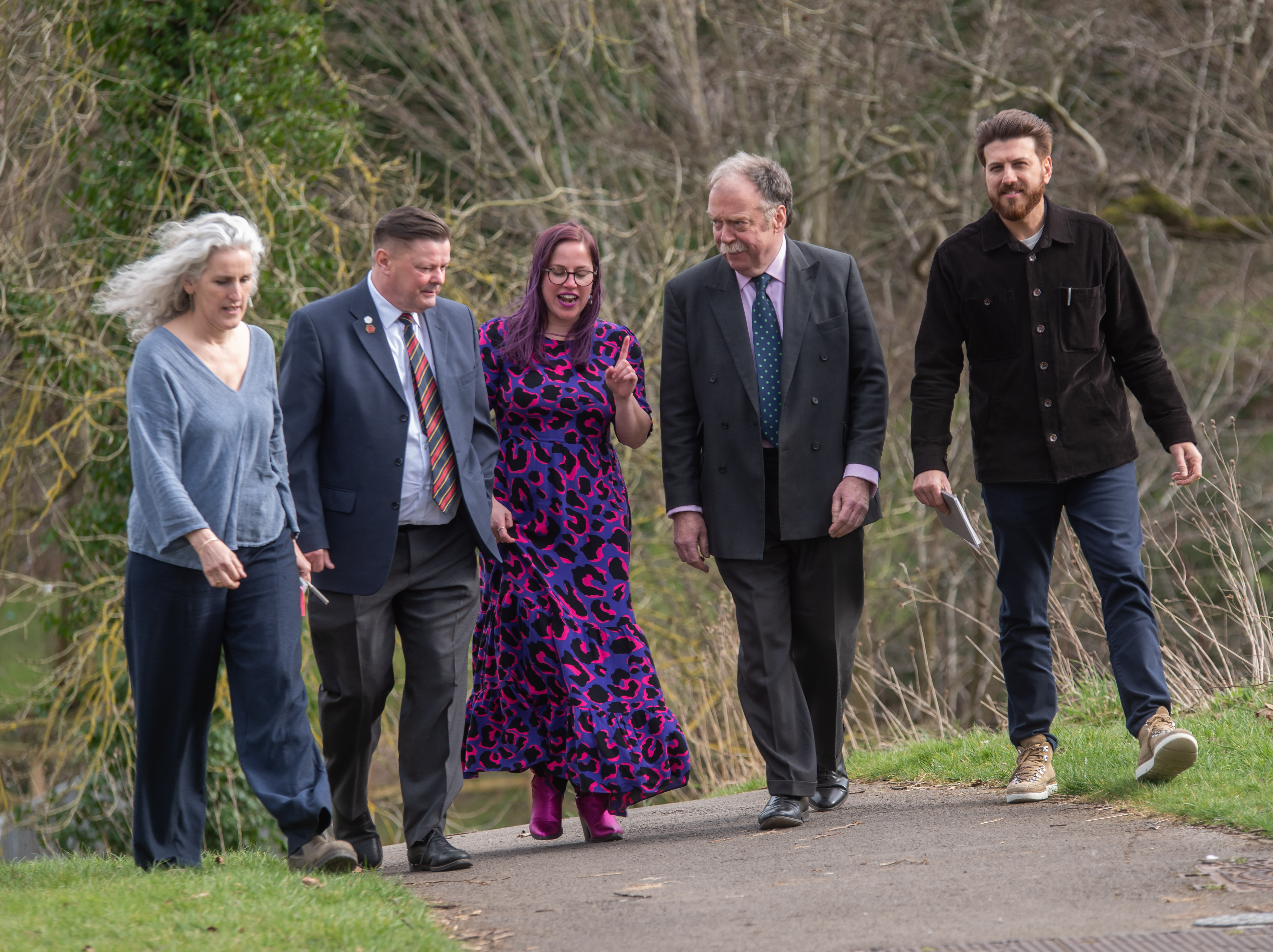 Group of people walking along a path chatting