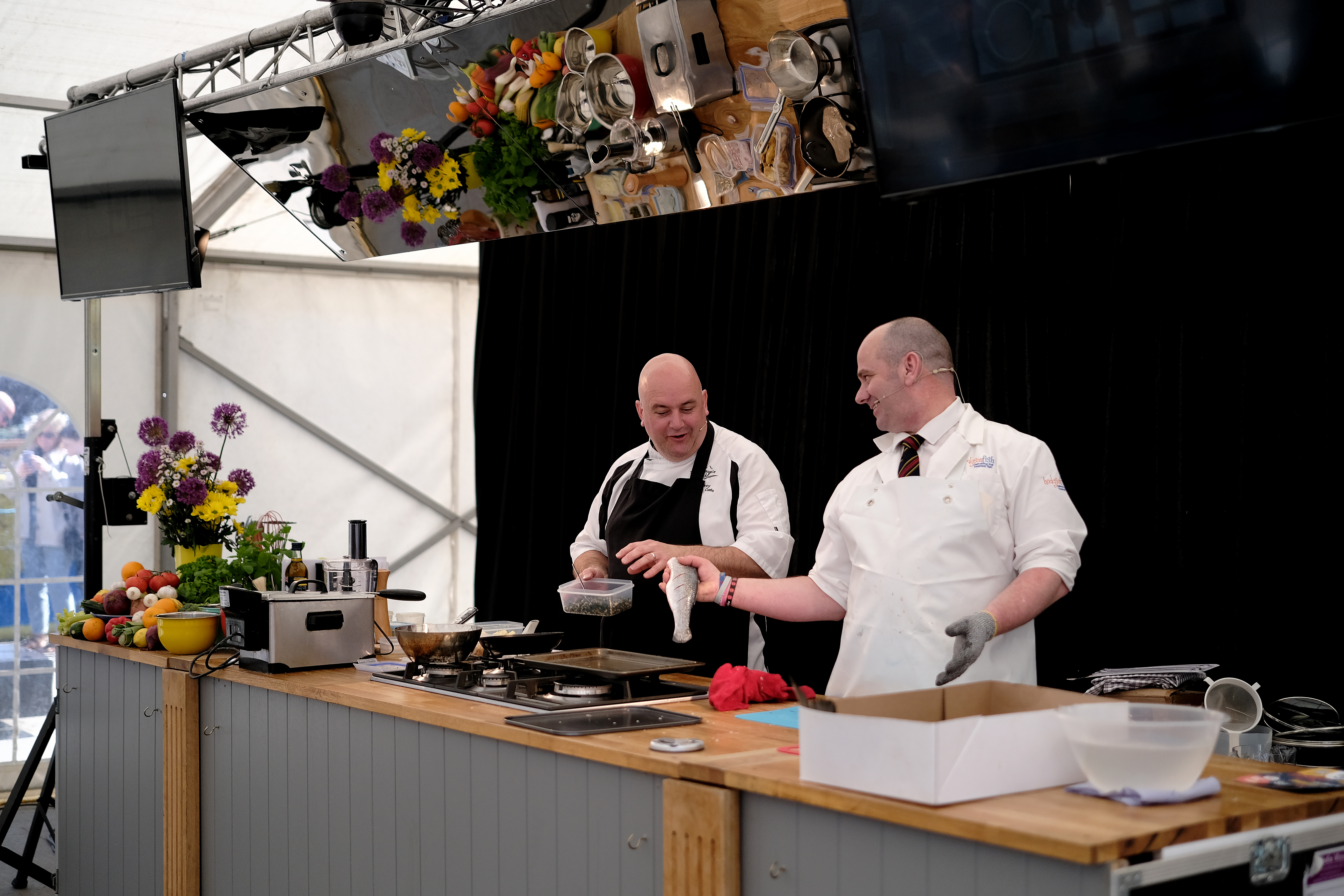Two adults cooking food at the Fish and Ships Festival