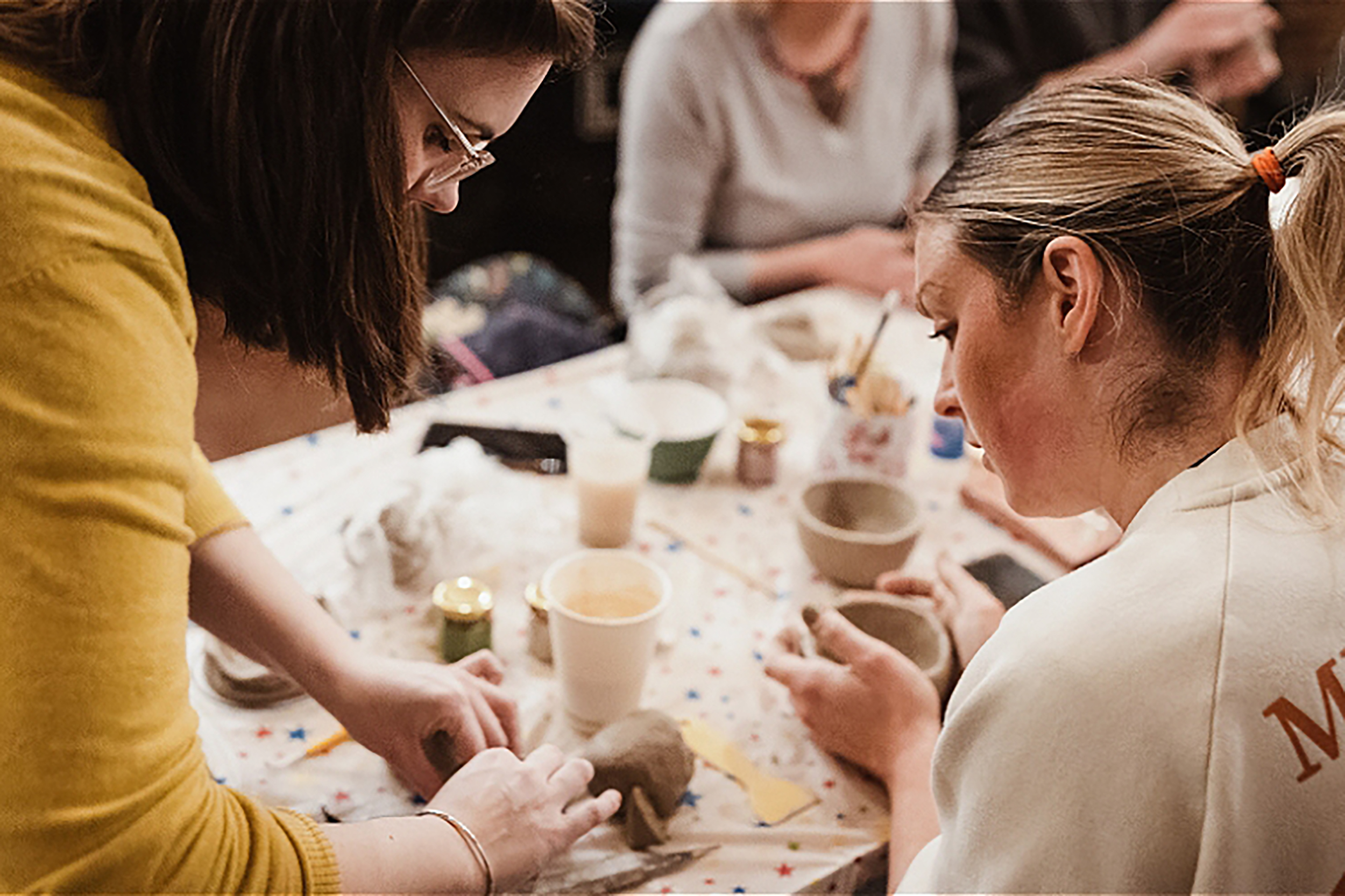People at a table enjoying crafts at The Scarborough Fair