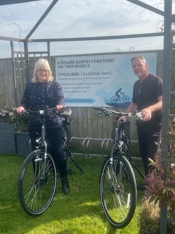 Andrew and Sonia standing with their bicycles