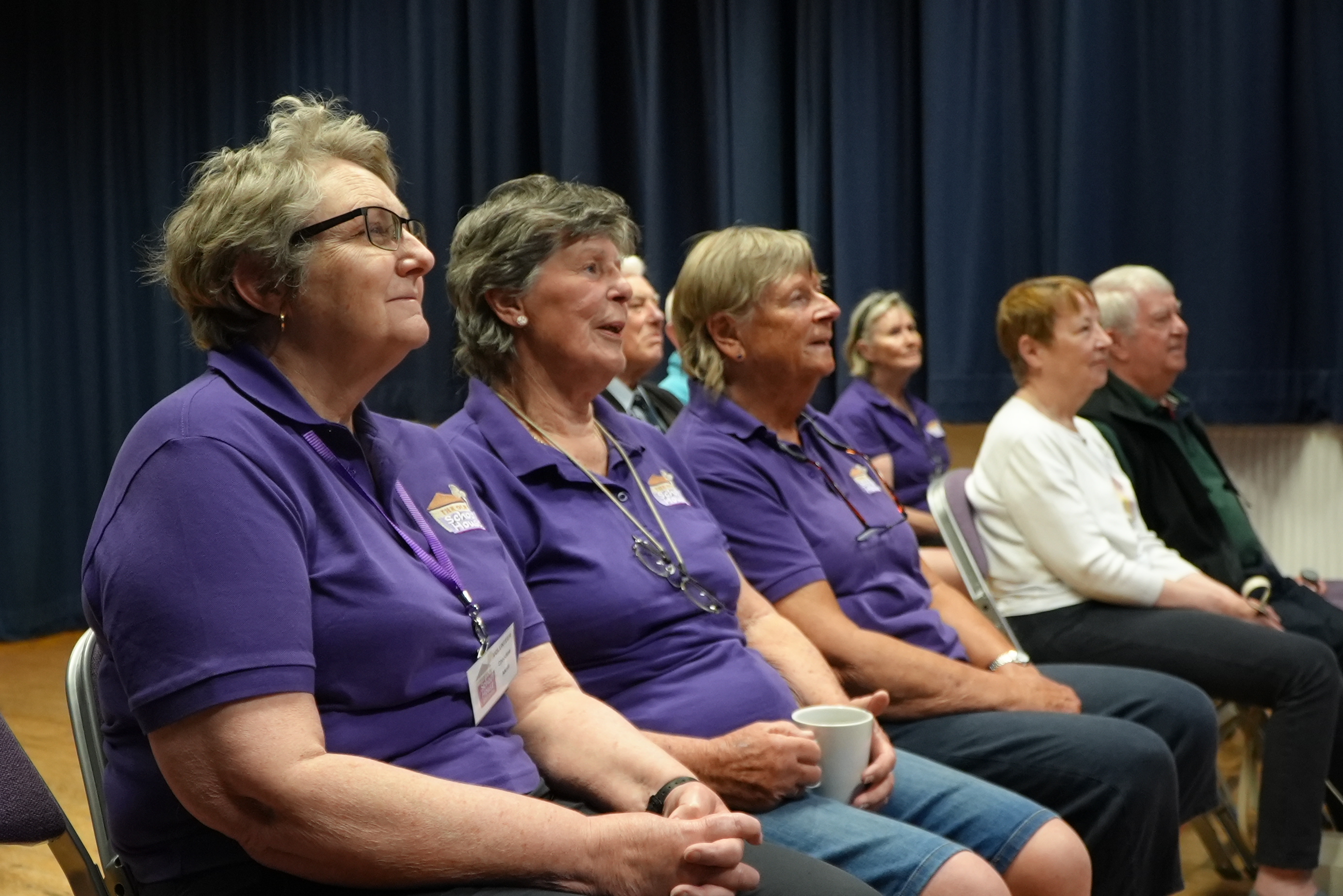 Group of volunteers sitting on chairs