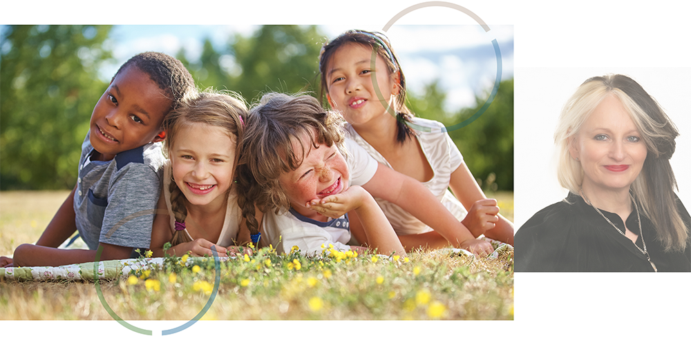 Group of children lying on the grass smiling