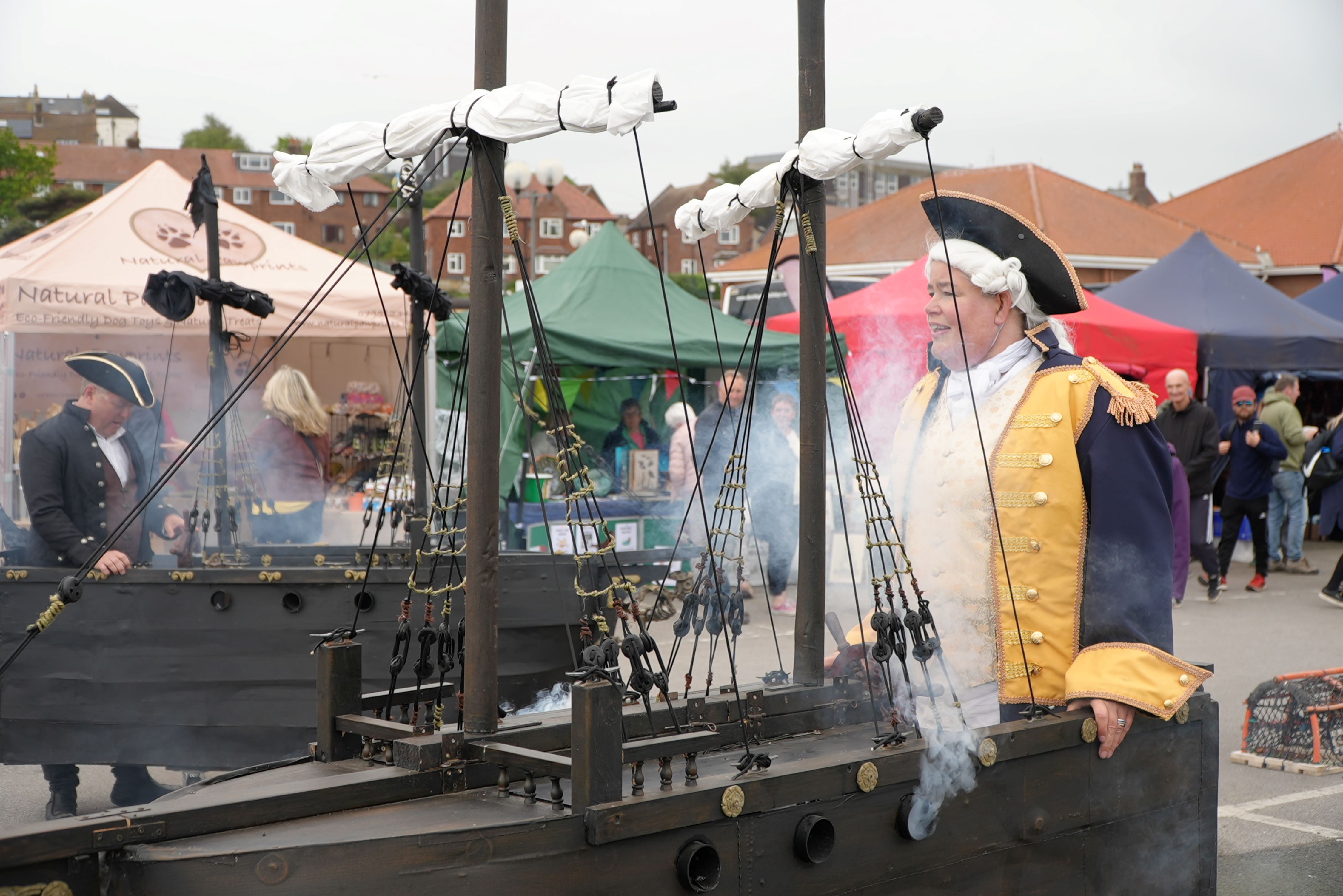 Someone dressed as a captain with a ship
