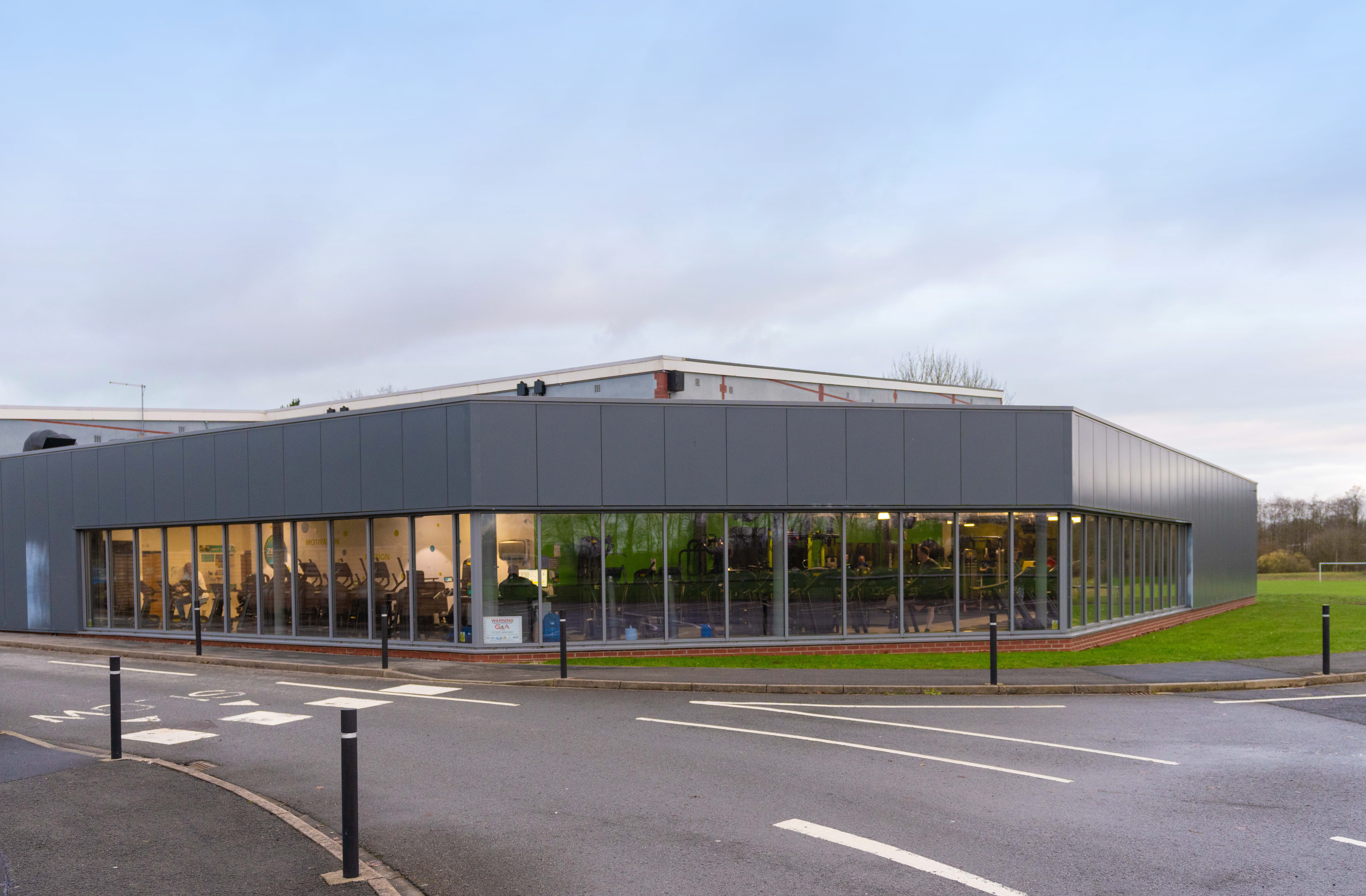 A view of the outside of Northallerton Leisure and Wellbeing Hub, people exercising are just visible within