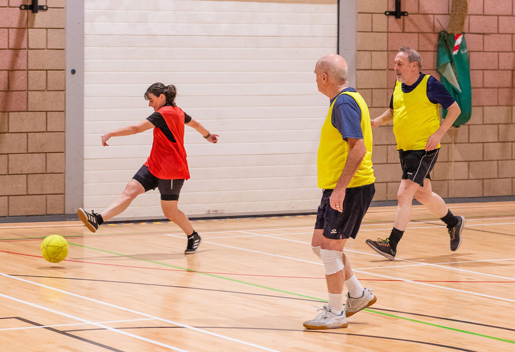 A group of men and women playing five-a-side football in the sports hall at Northallerton Leisure and Wellbeing Hub