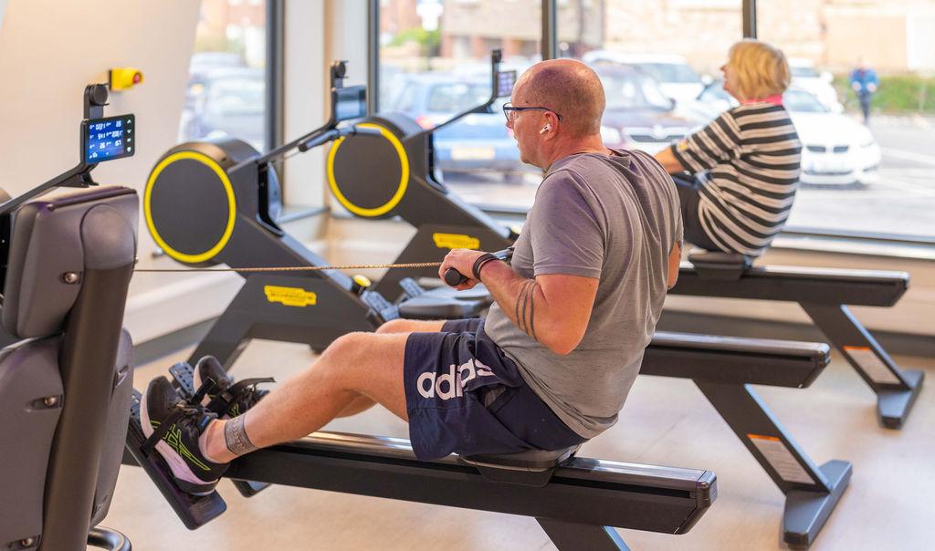 A man and a woman using rowing machines at Thirsk and Sowerby Leisure and Wellbeing Hub