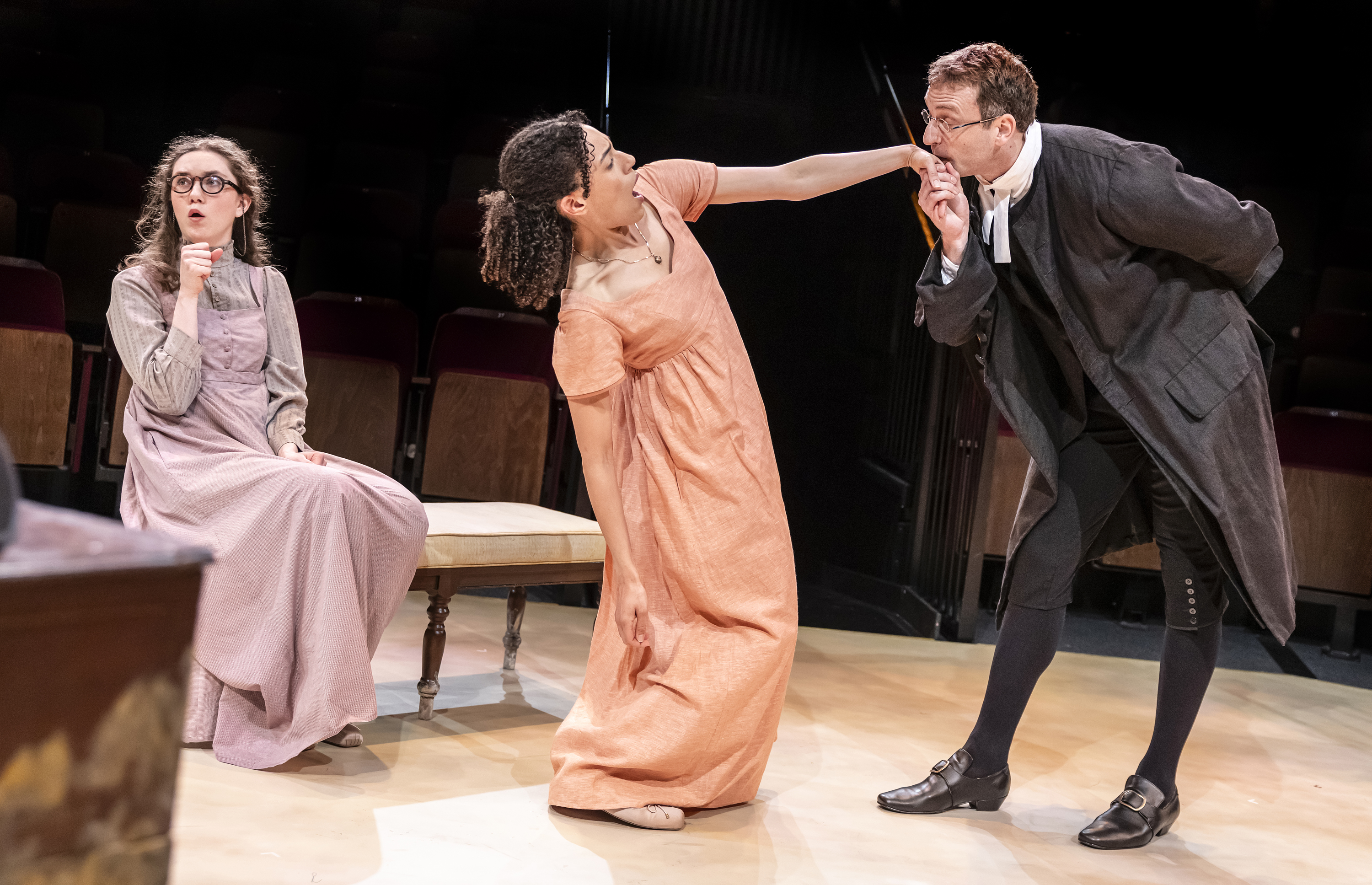 Three people on stage in costume performing a scene from Pride and Prejudice. Credit Pamela Raith Photography
