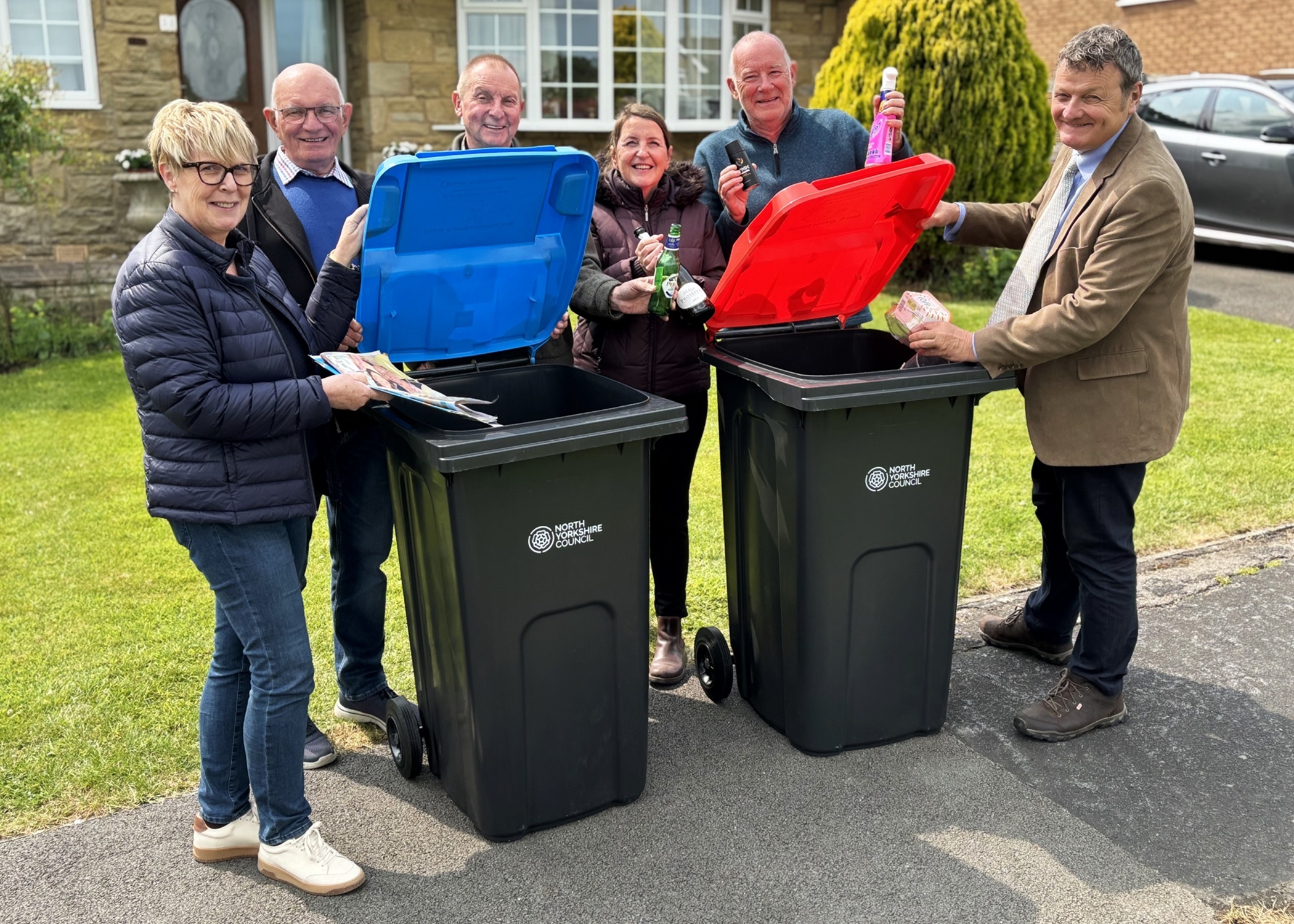 Cllr Greg White and residents putting items in the bin