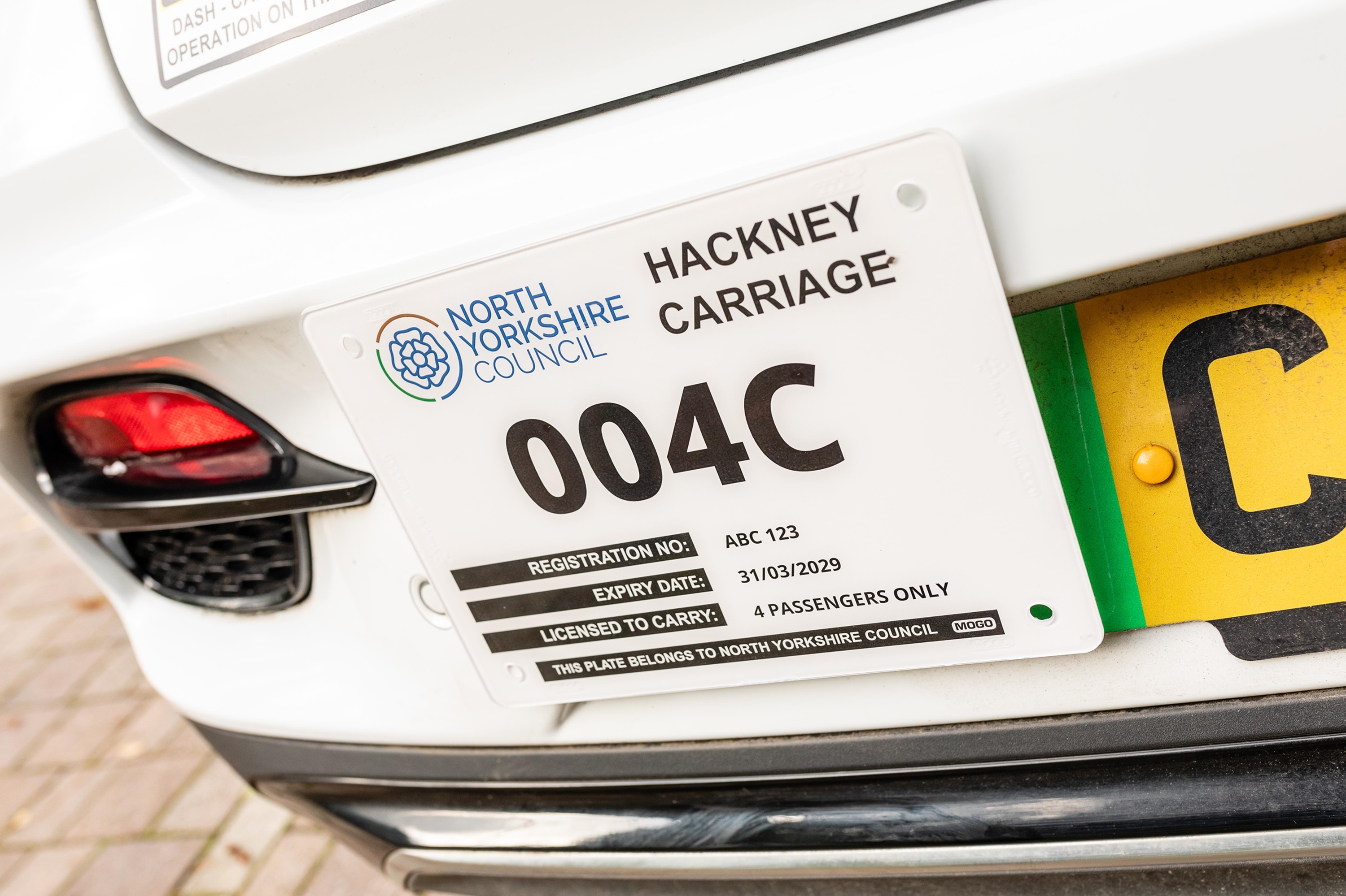 The back of a taxi showing the taxi licence 