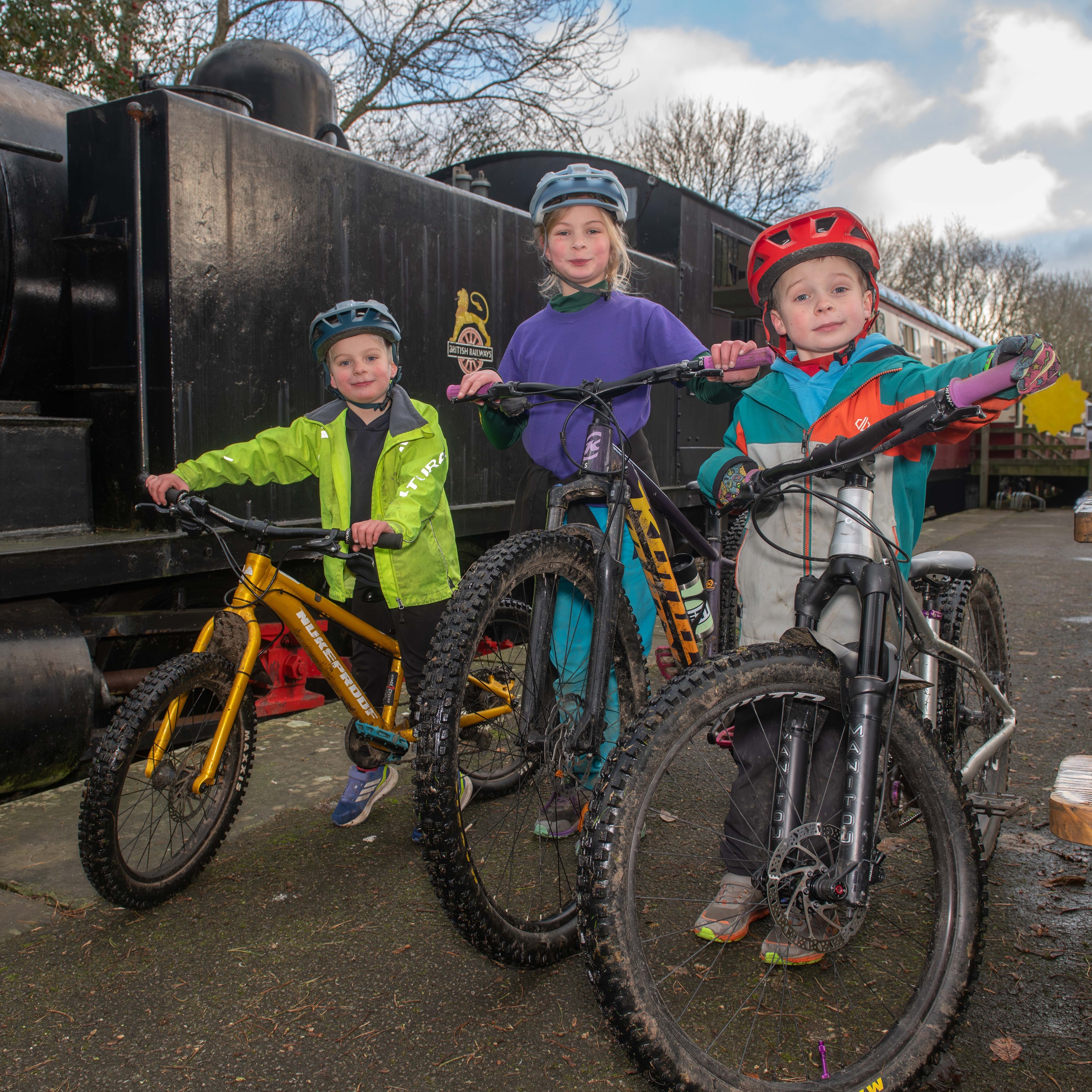 Three young children on a bike