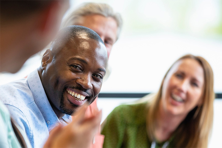 A group of adults talking and laughing.