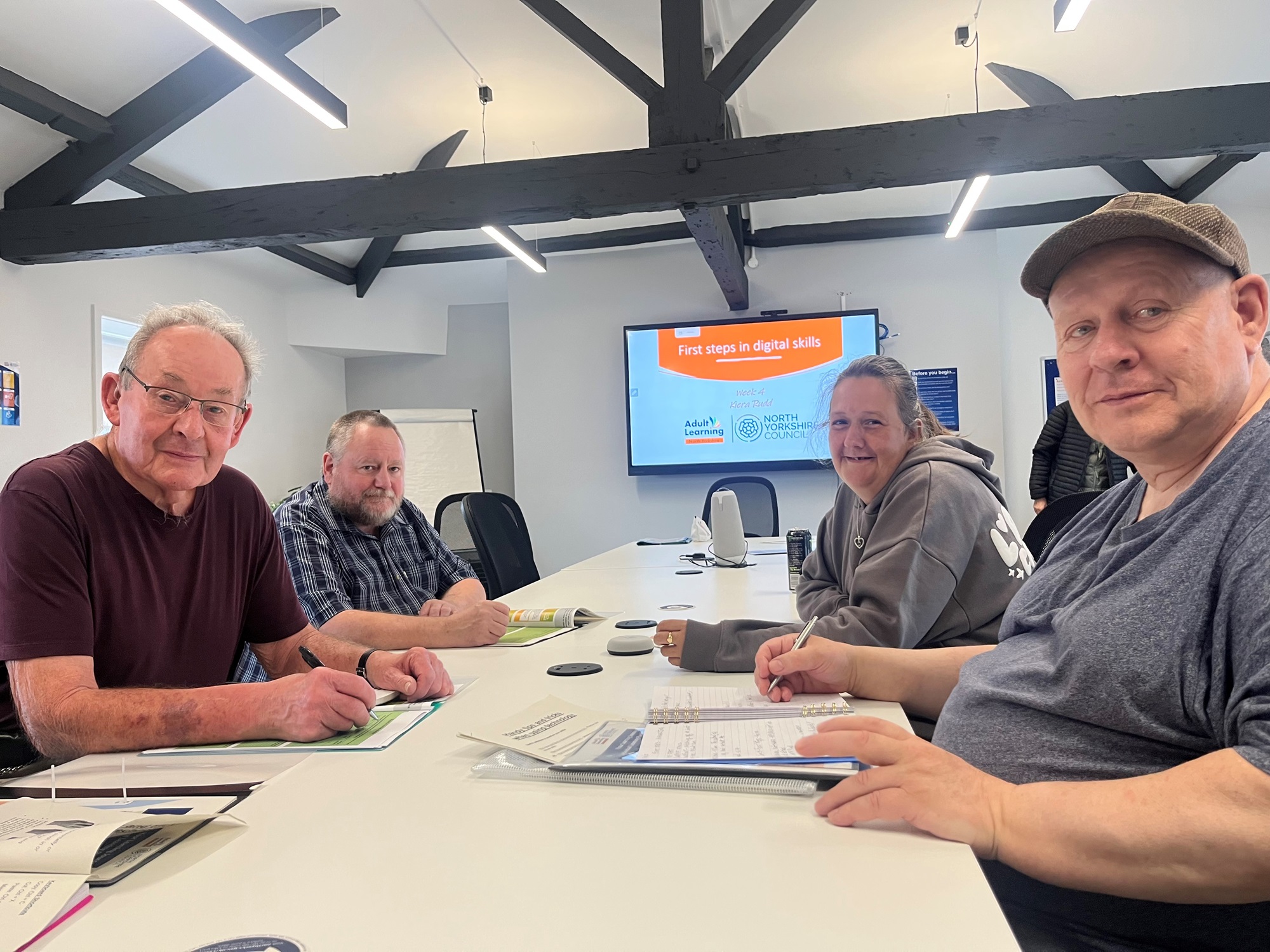 Four adult learners in a class room