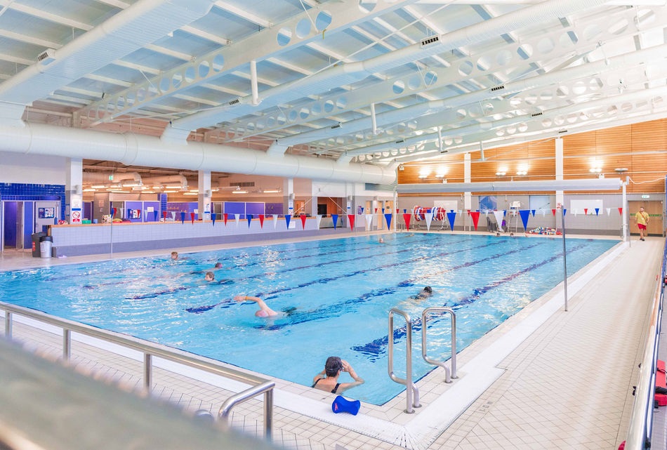 A view of the swimming pool at Skipton Leisure and Wellbeing Hub, some people are in the water.