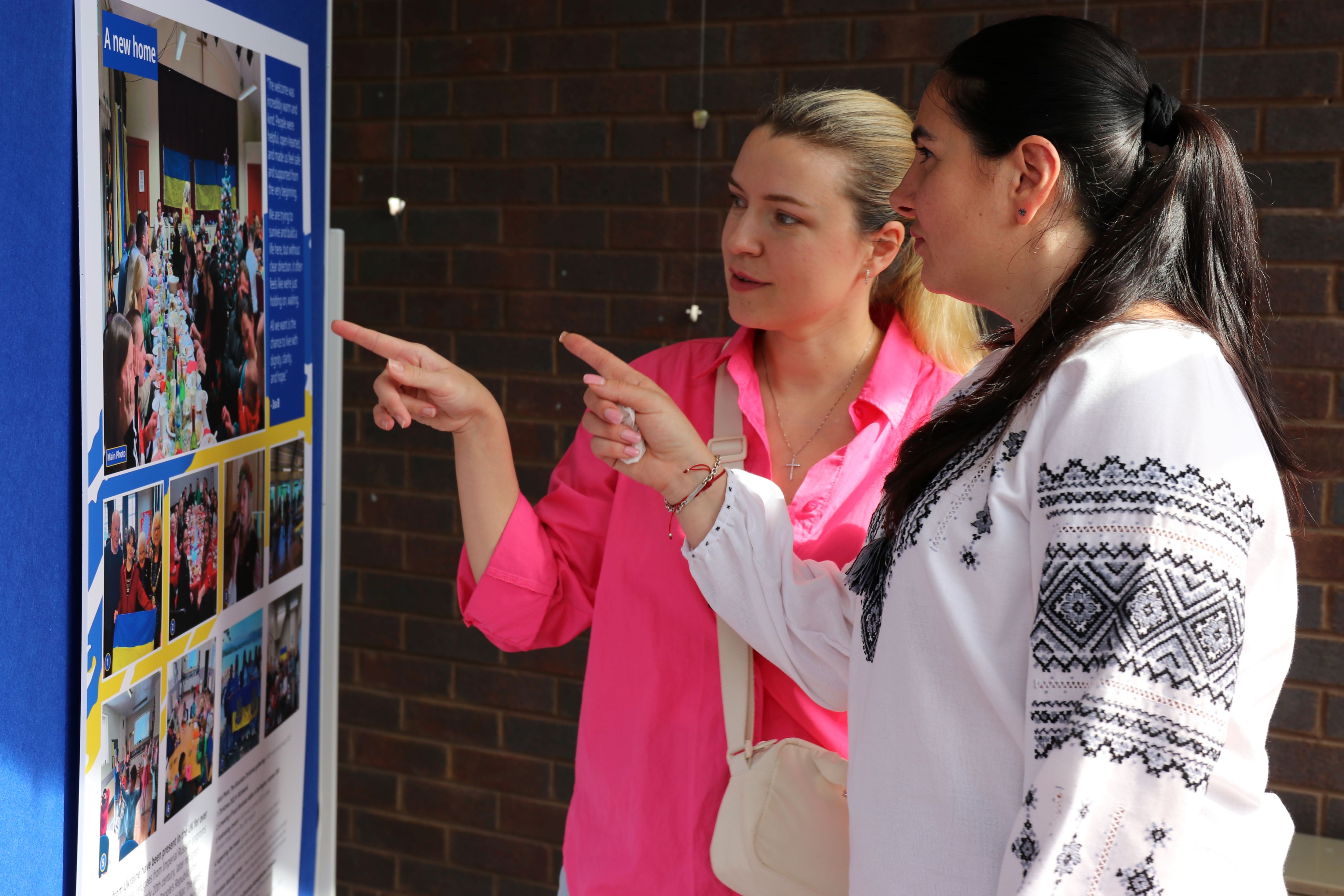 Two adults looking at a display at the Ukrainian exhibition
