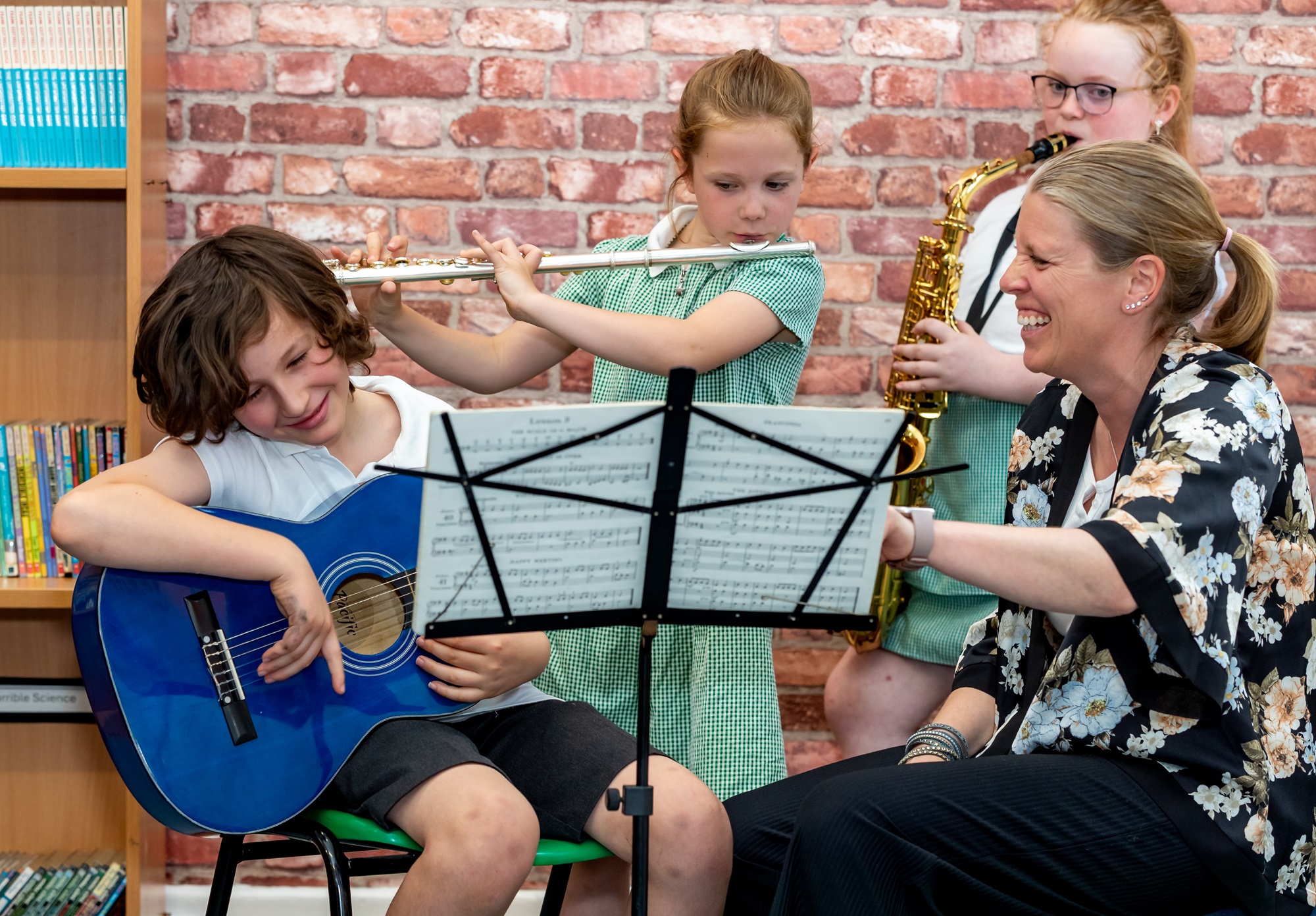 Young North Yorkshire music students playing guitar, flute and saxophone.