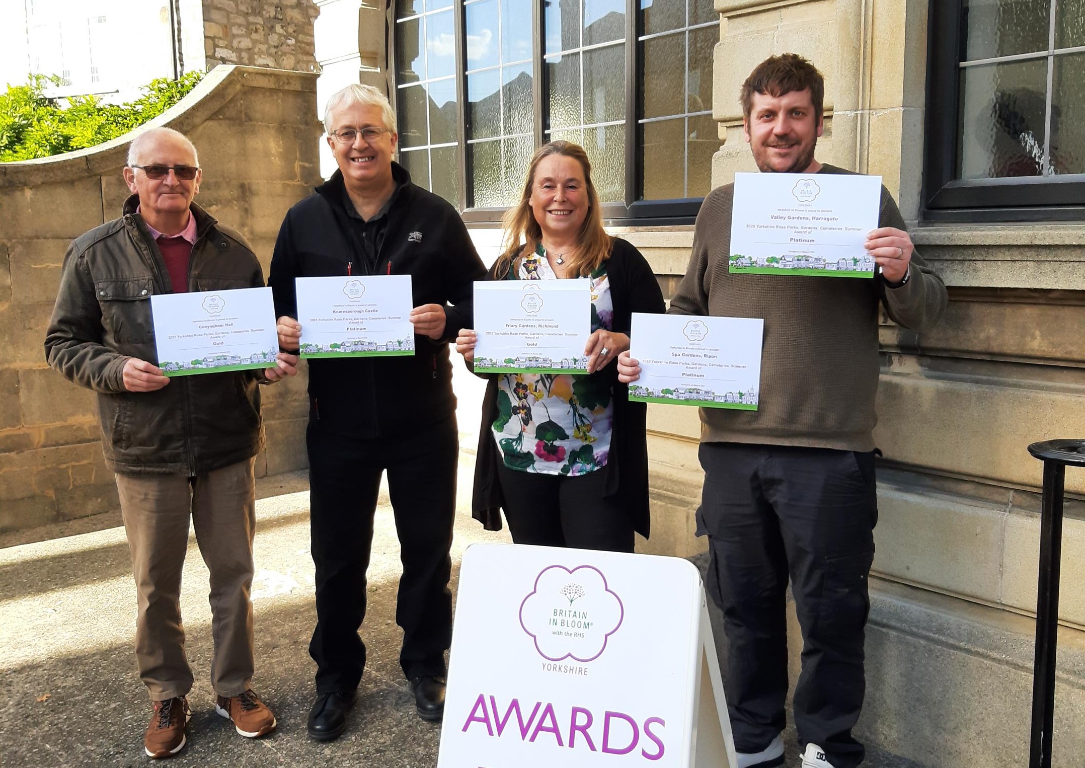 A group of four holding certificates at the Yorkshire in Bloom awards