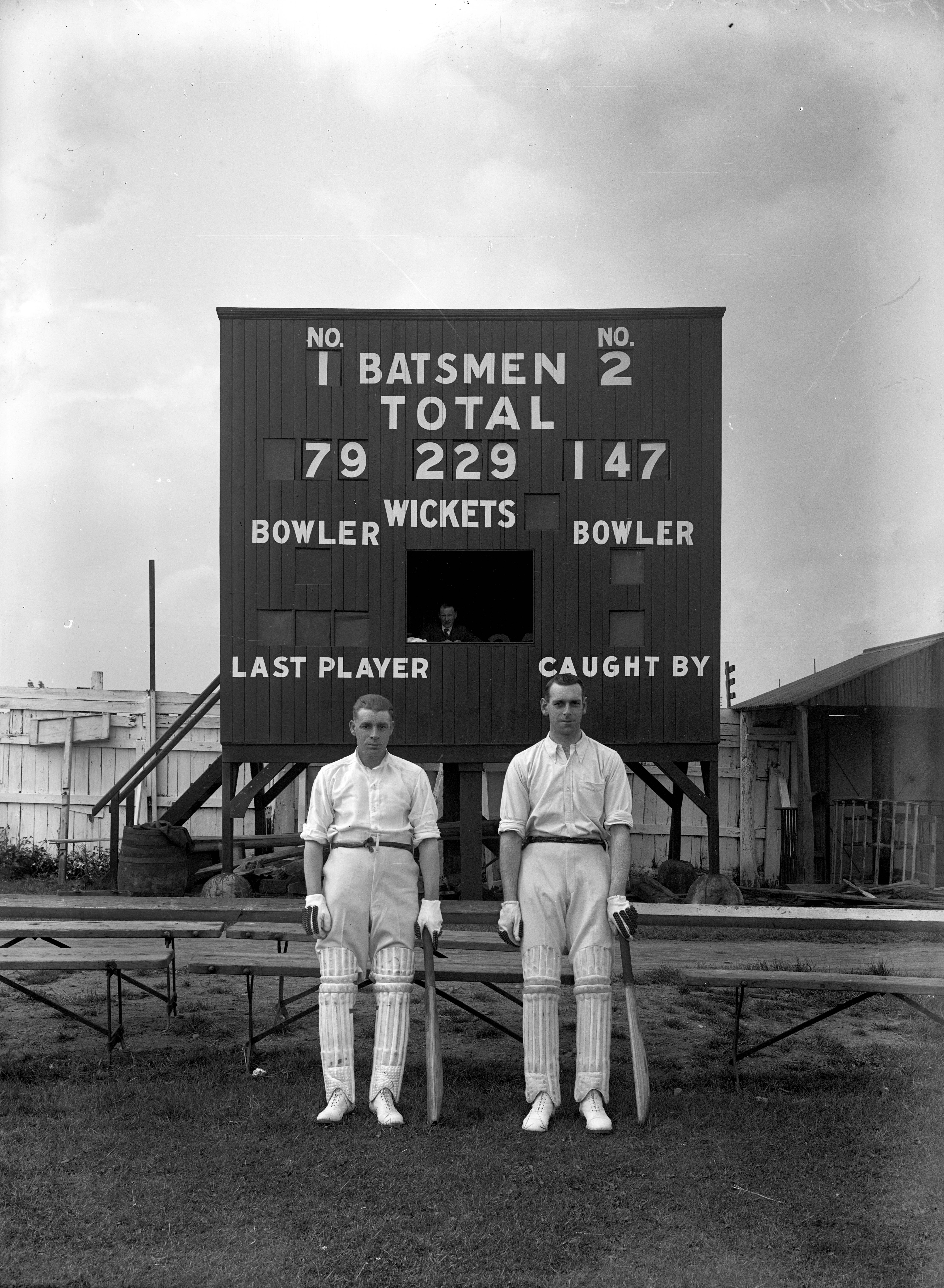 Openers and scoreboard at a match between Harrogate and Leeds cricket clubs in 1923.