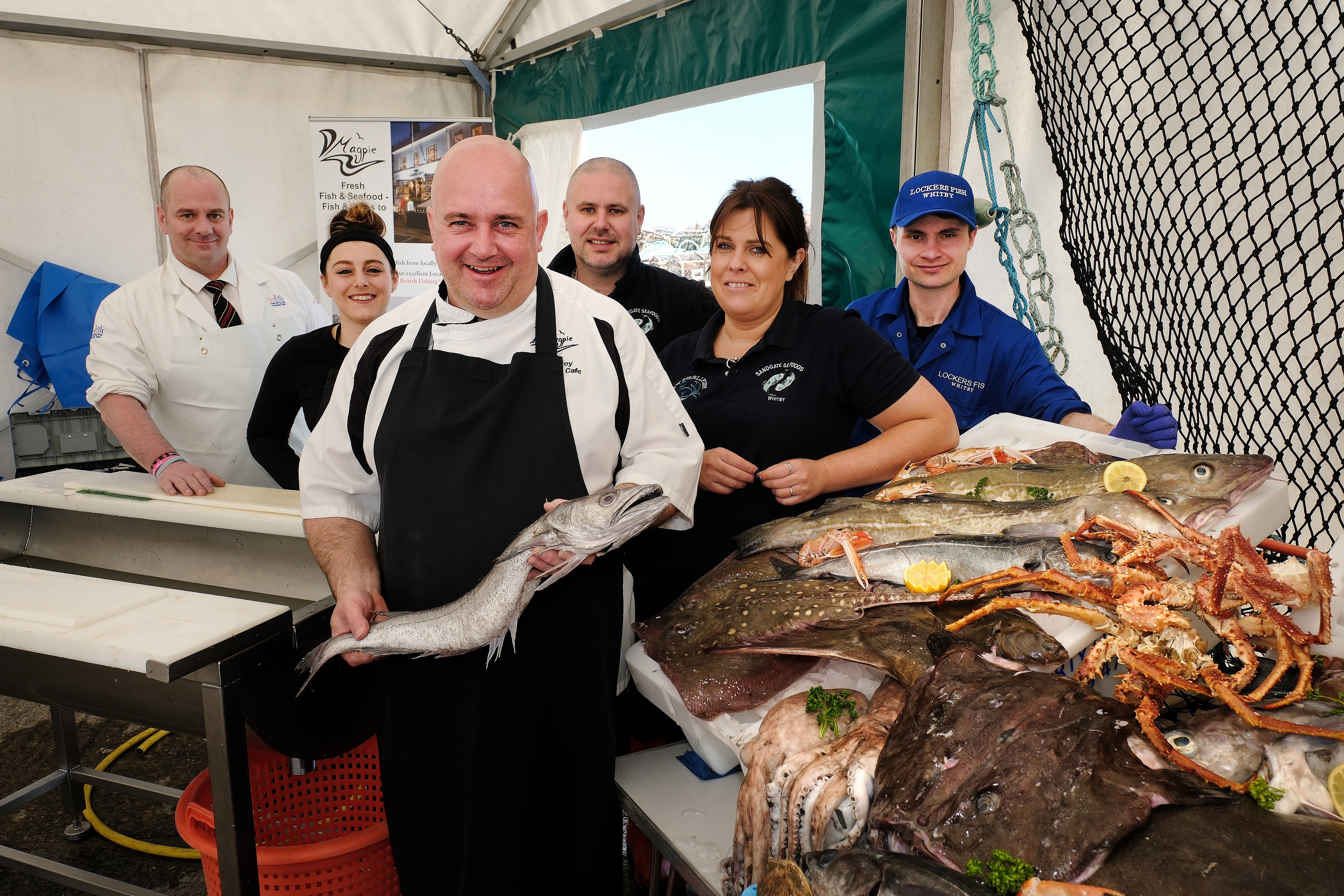 A group of chefs with a fish at Whitby Fish and Ships festival