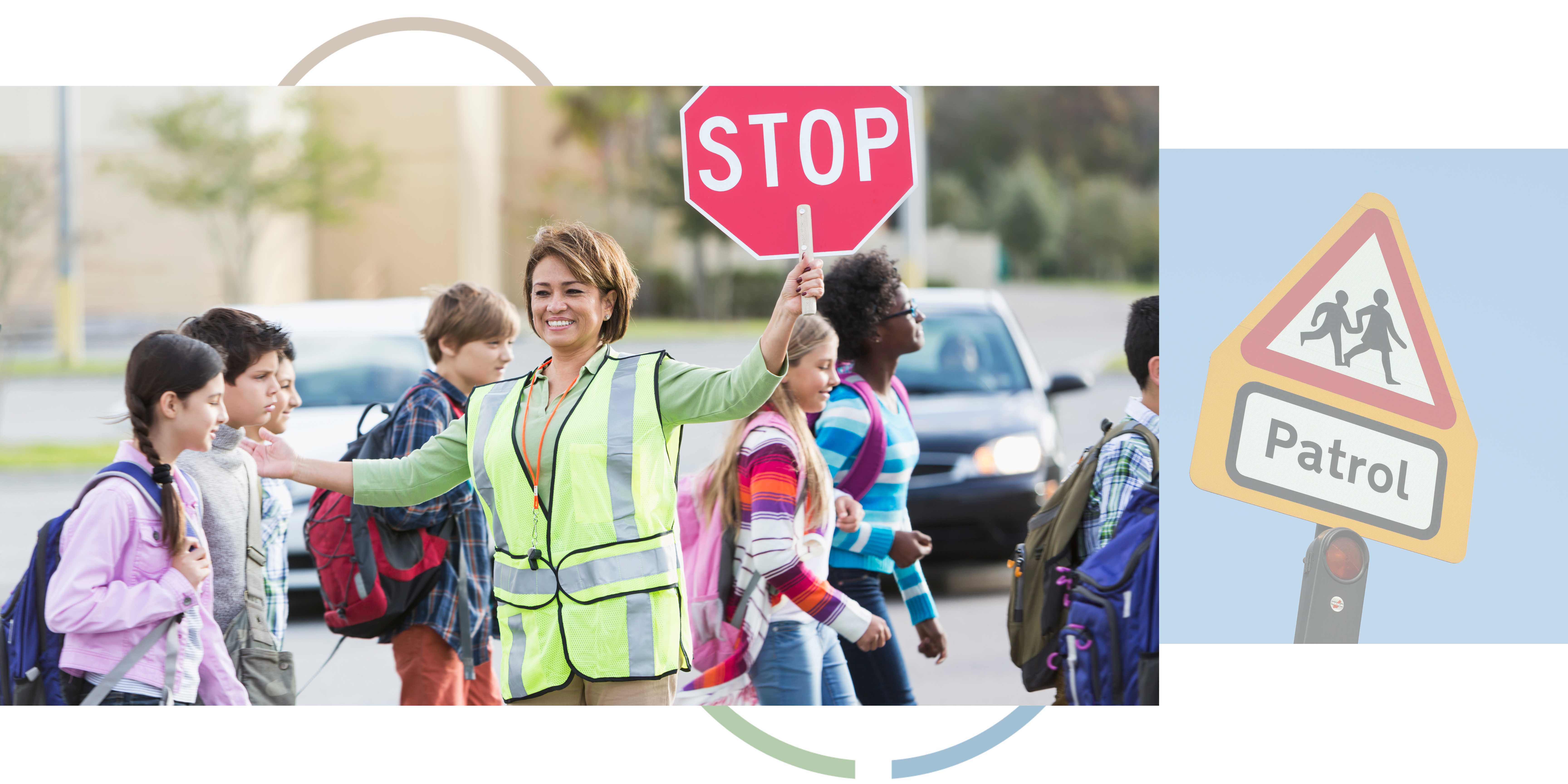 Crossing officer helping children across the road.