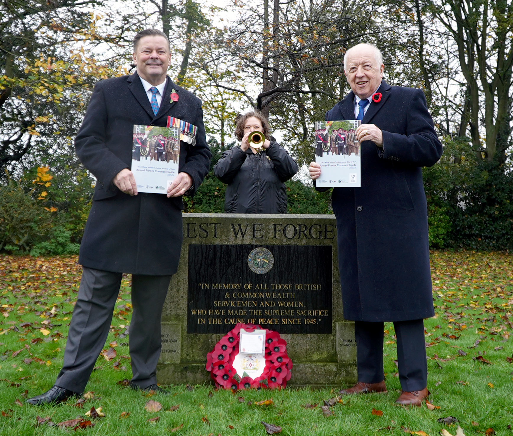 Two men holding the guide for Armed Forces personnel