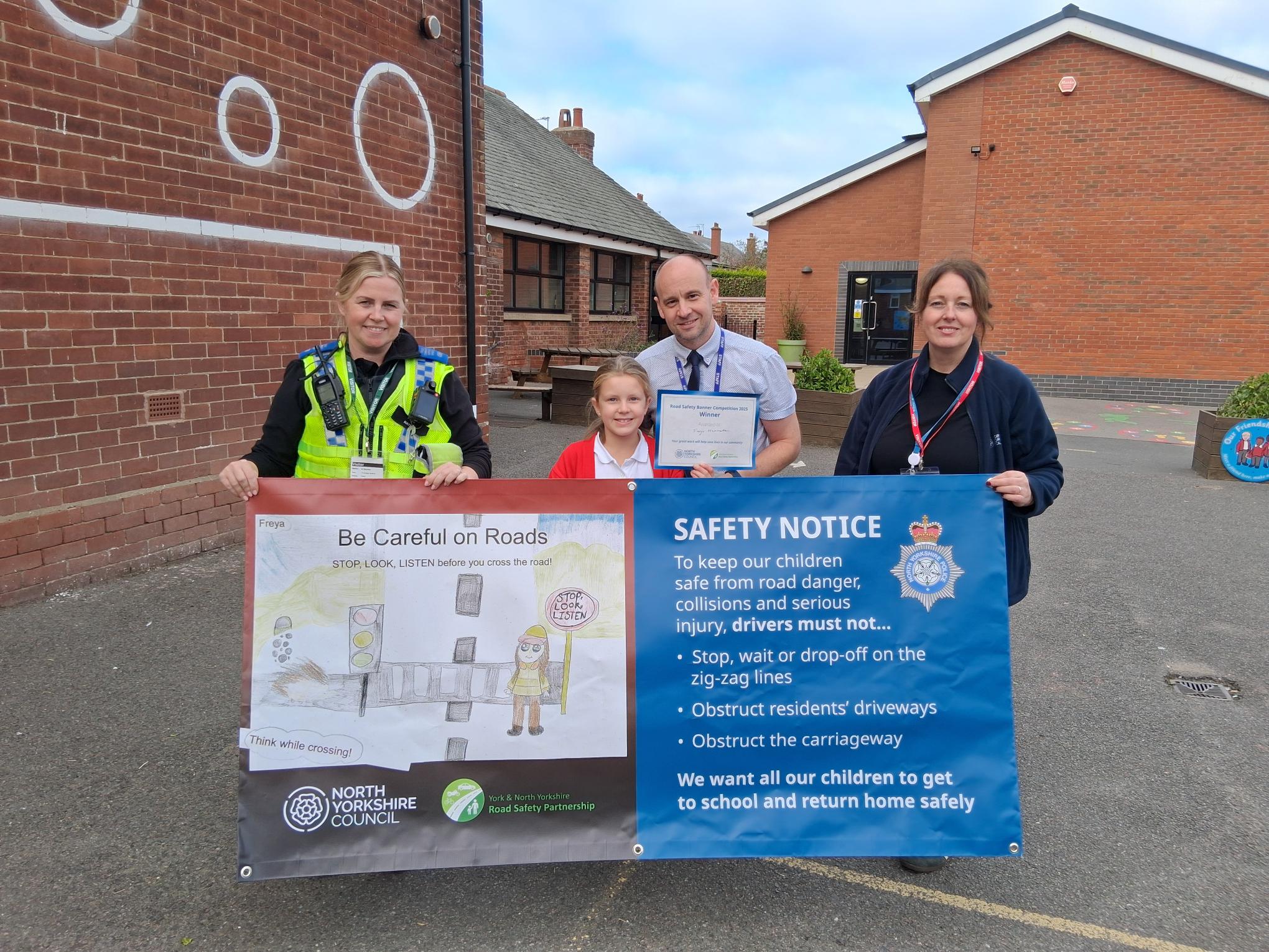  From left, Police Community Support Officer at North Yorkshire Police, Natalie Blacker, Filey Junior School pupil Freya Hammerton, who is the winner of the banner competition, headteacher Michael Taylor, and community safety officer at North Yorkshire Council, Karen Nattress.