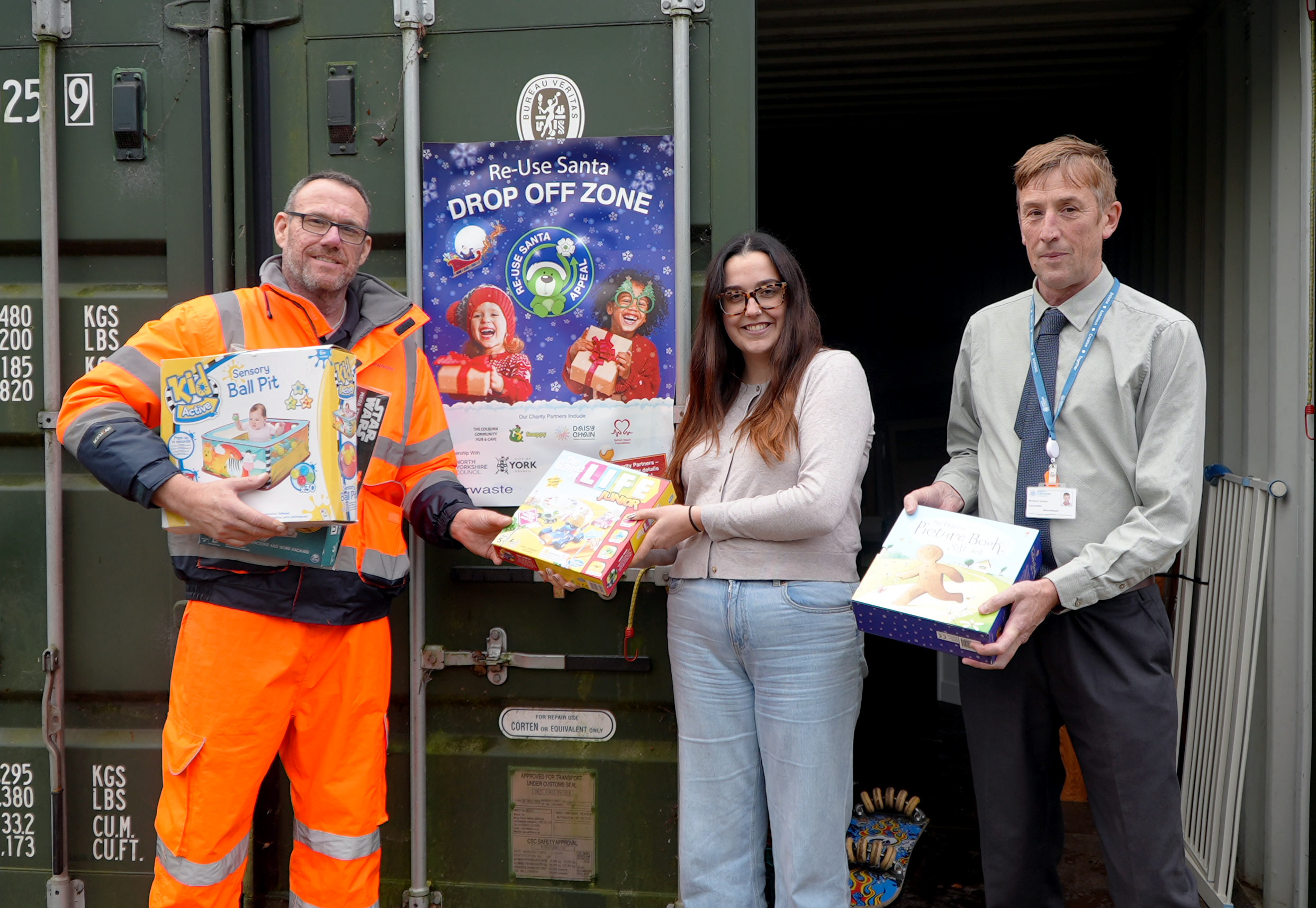 Three people at the household waste recycling centres with used toys
