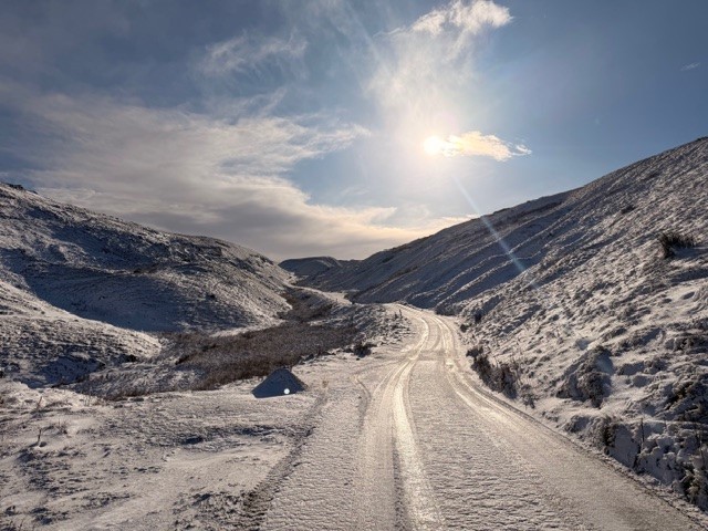A view of the snow covered road and hills at Askrigg West Moor