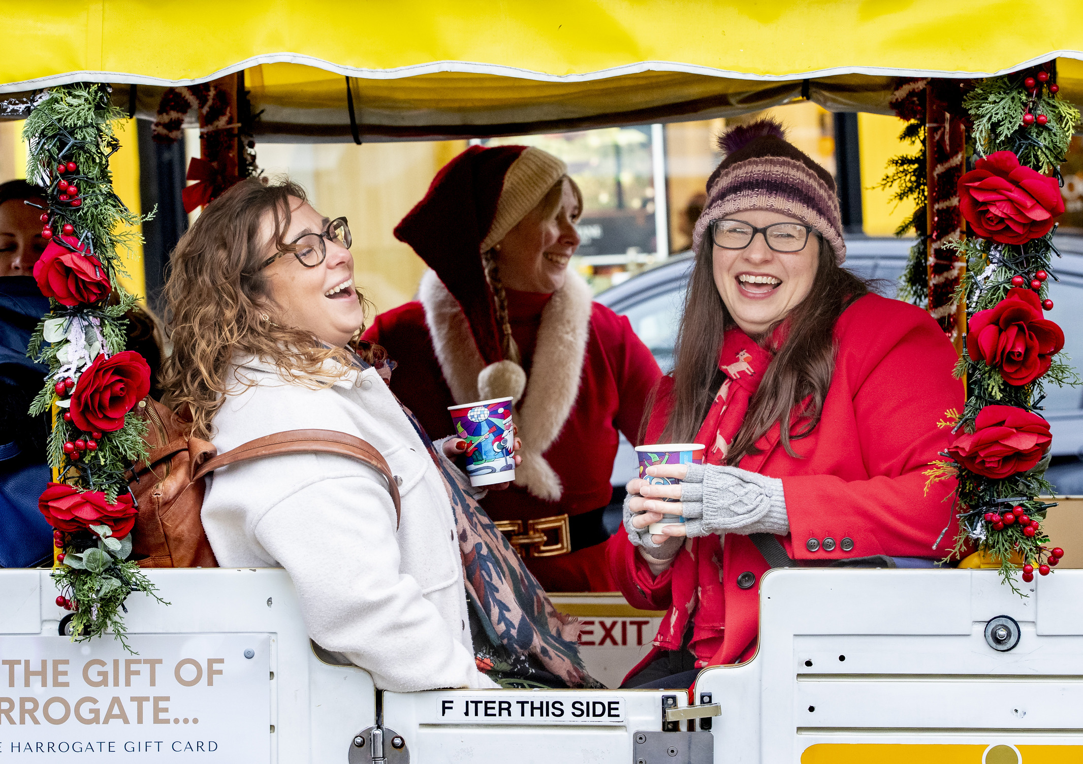 Adults riding on the Candy Cane Express Road Train drinking a warm drink. Credit Visit North Yorkshire Stephen Garnett Photography 