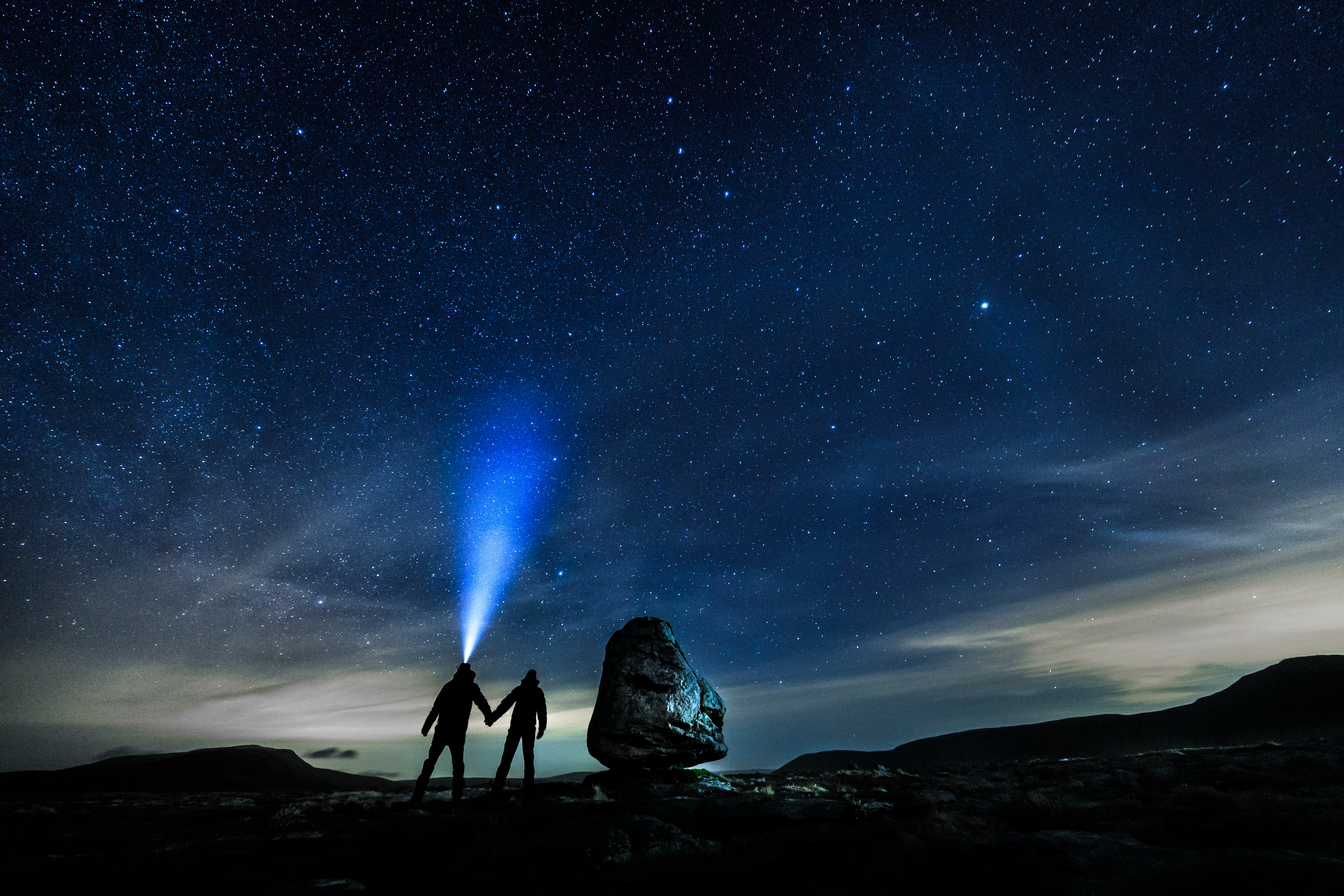 Two people walking in the dark in the Dales stargazing