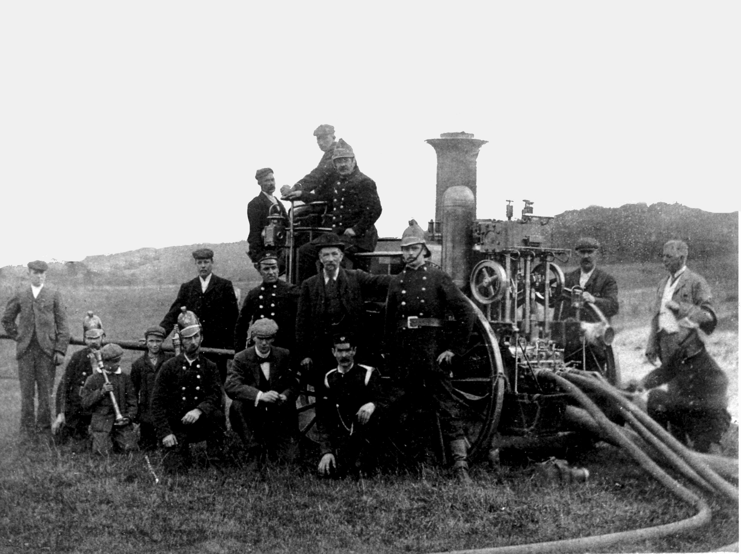 Black and white photo of the Skipton Fire Brigade surrounding their fire engine