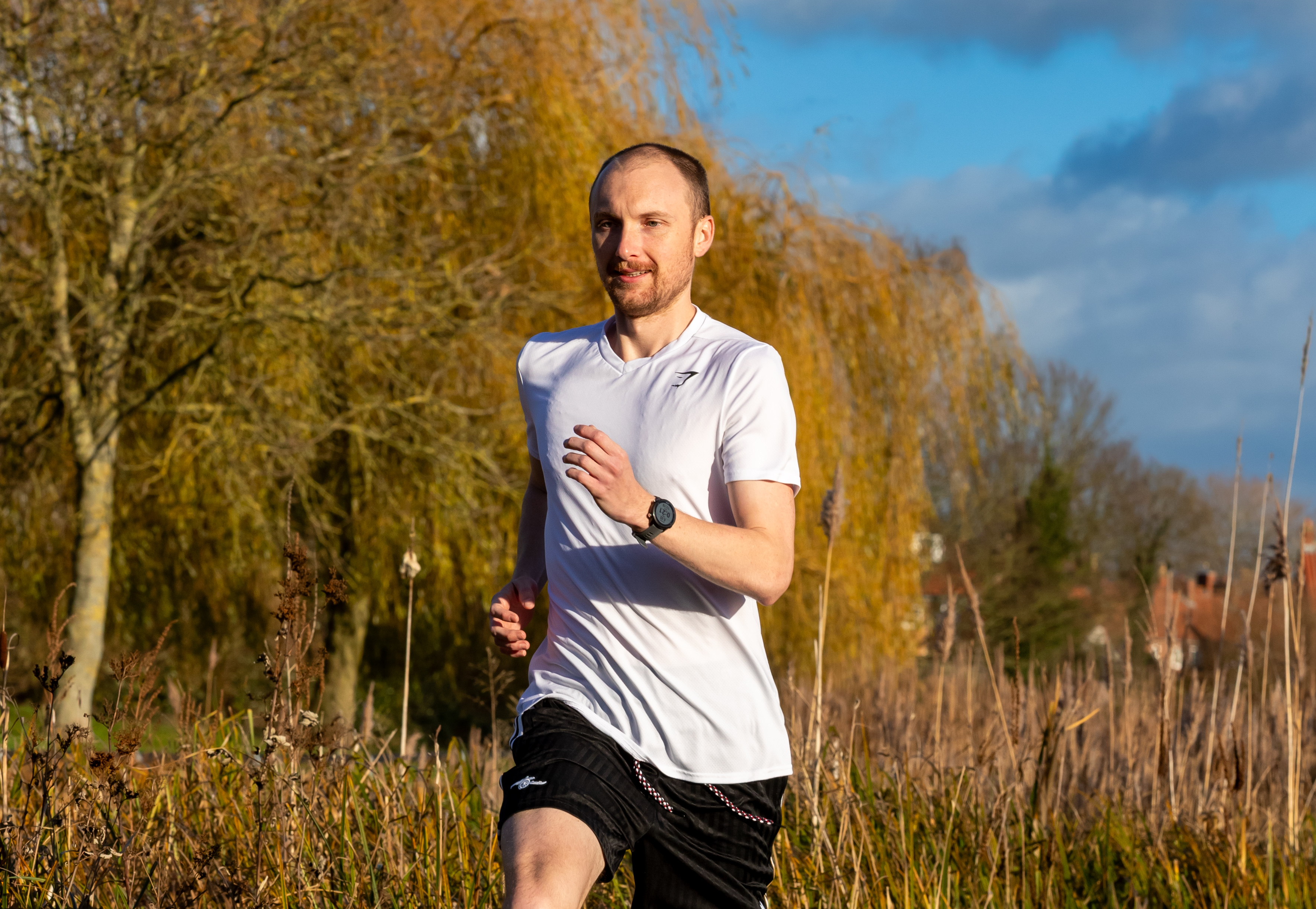 Adult running outside on a bright day