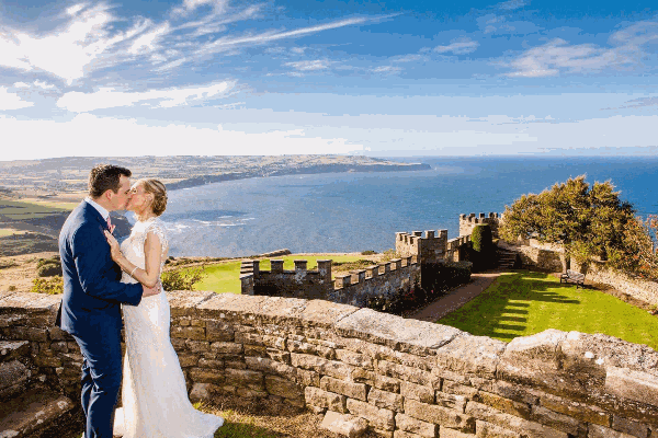Couple on their wedding day with the sea behind them