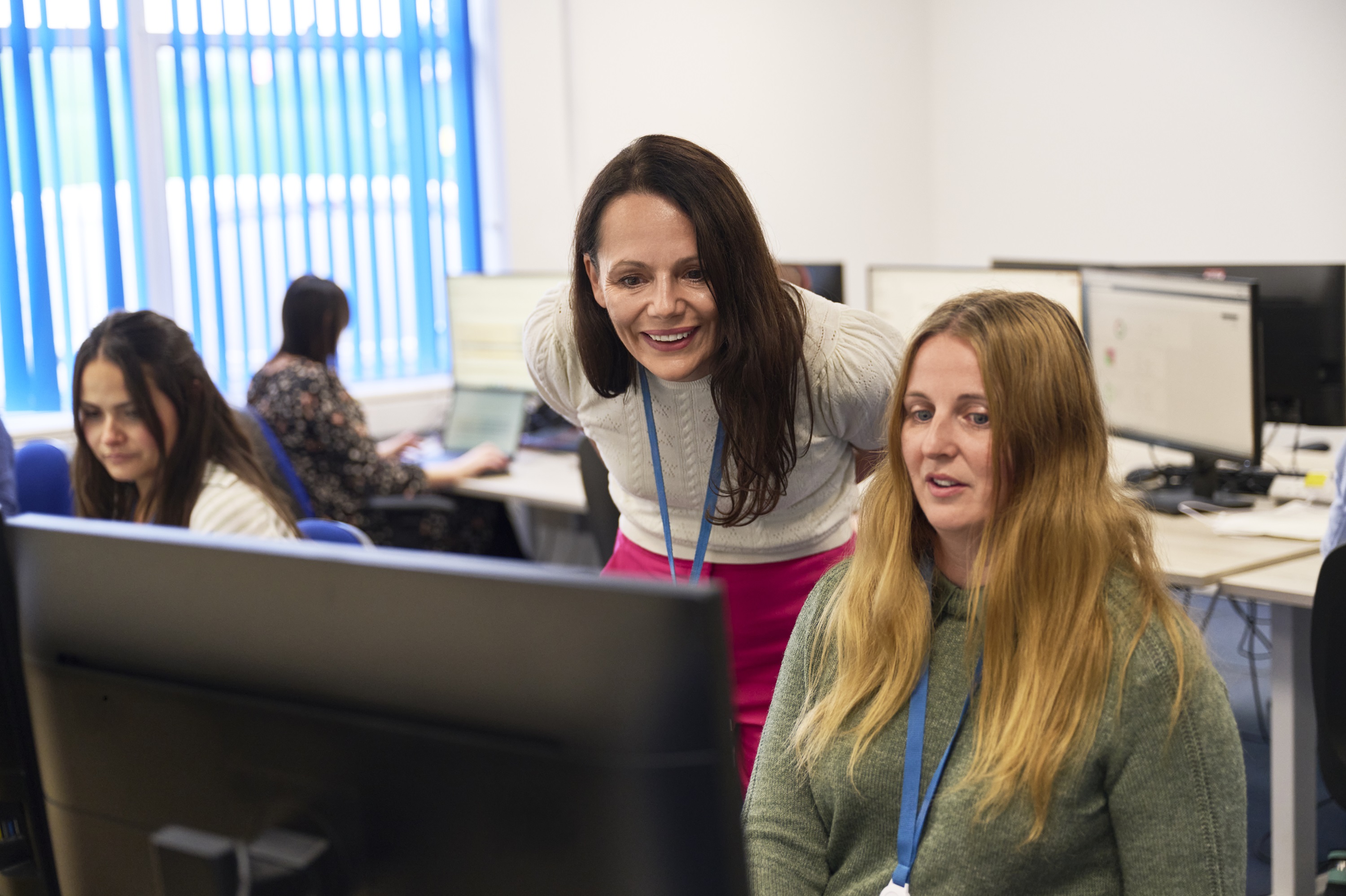 Group of people sitting at desks working