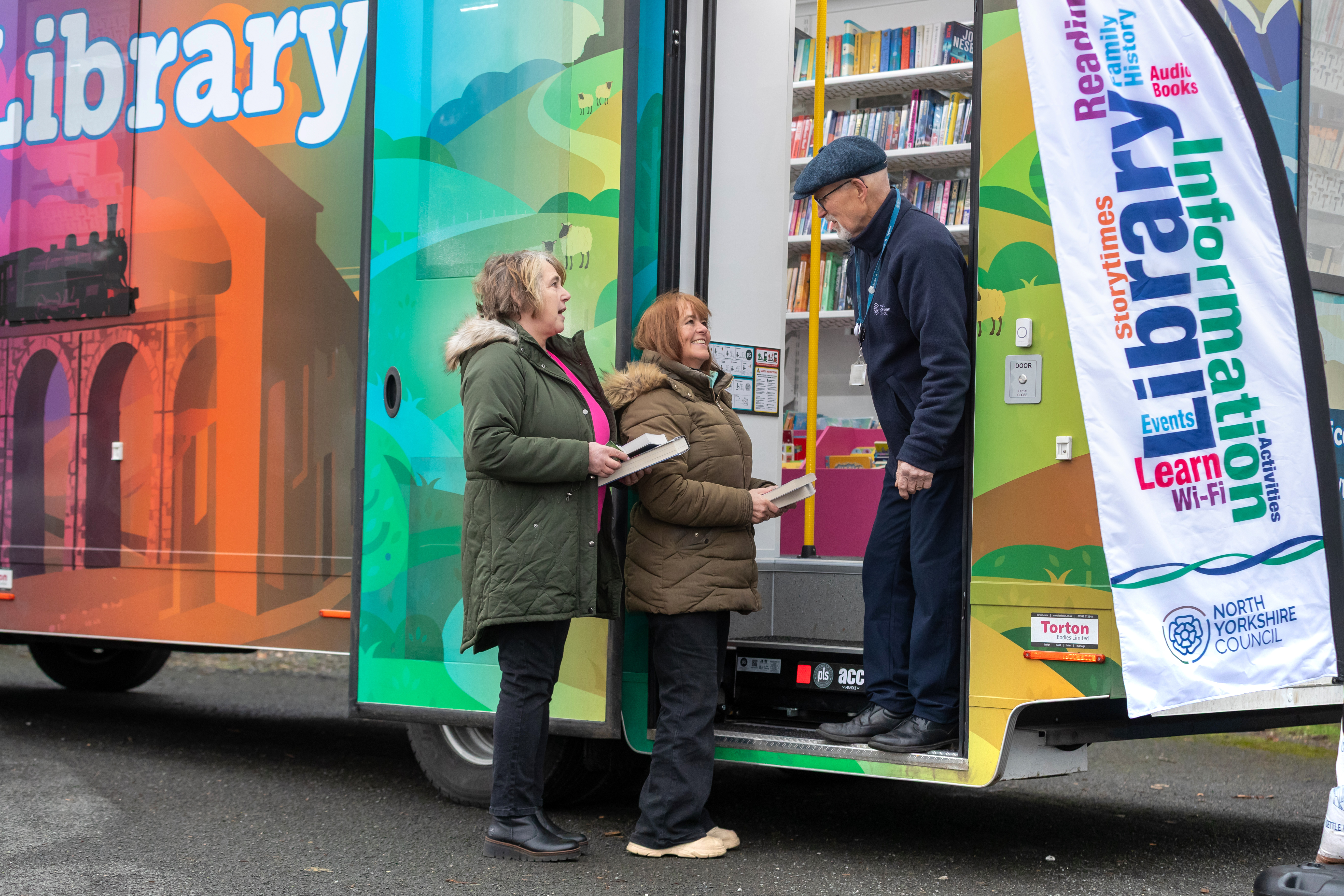 Driver Nick Lombard on the steps of the new mobile library with Kath Jackson and Lorraine Leary, who sit on Horton in Ribblesdale Parish Council. 