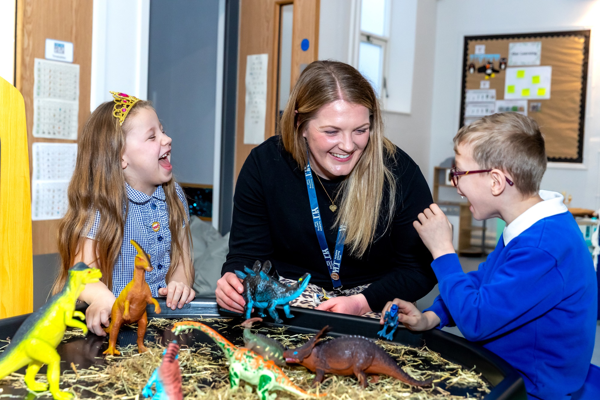 A teacher and two children in school