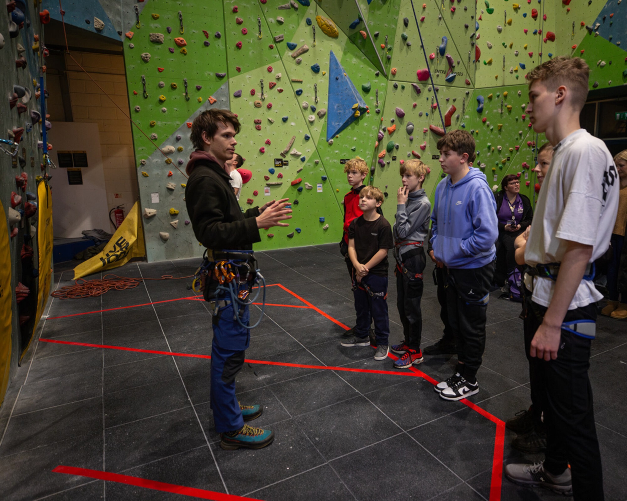 Young people and an instructor at a climbing wall