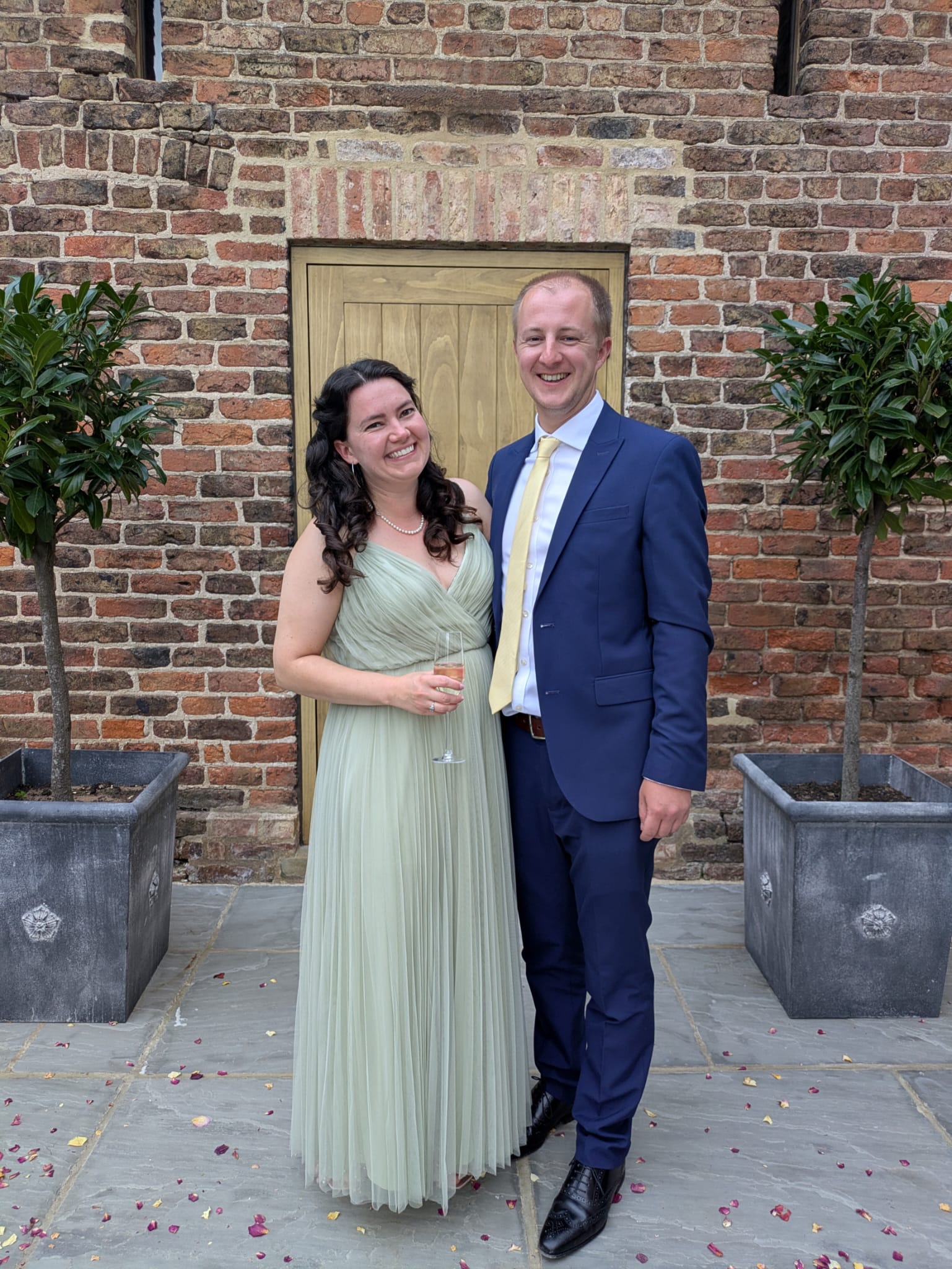 Photo of a couple standing together outside on their wedding day.
