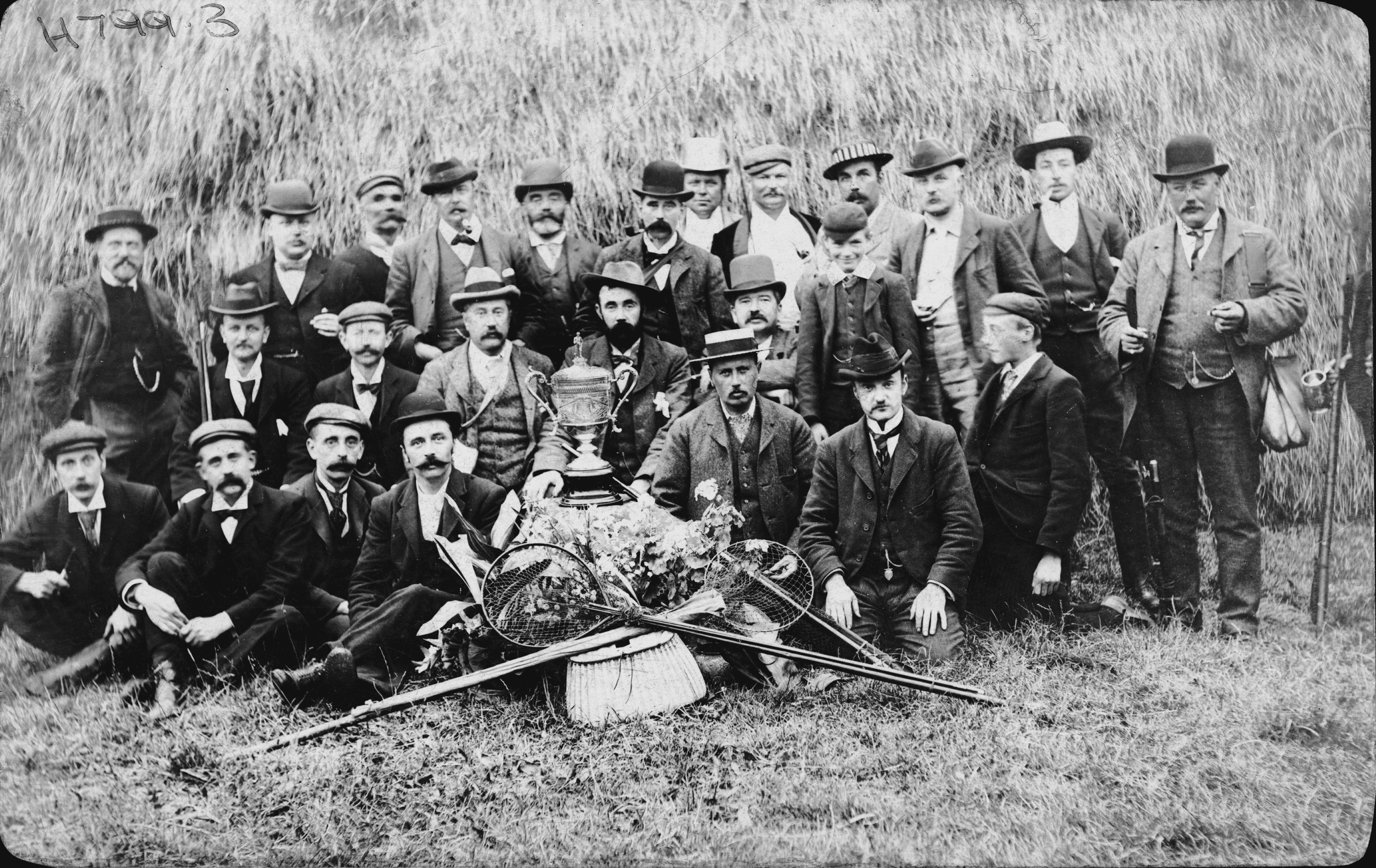 Black and white photo of Members of Harrogate fishing club pictured with a trophy in about 1908